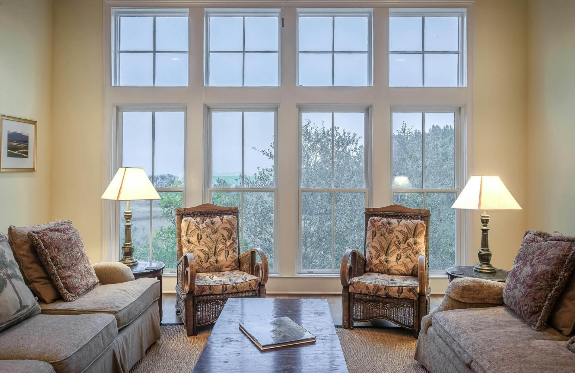 Classic living room with matching table lamps on both sides, creating symmetry and ambient glow in a window-lit space.