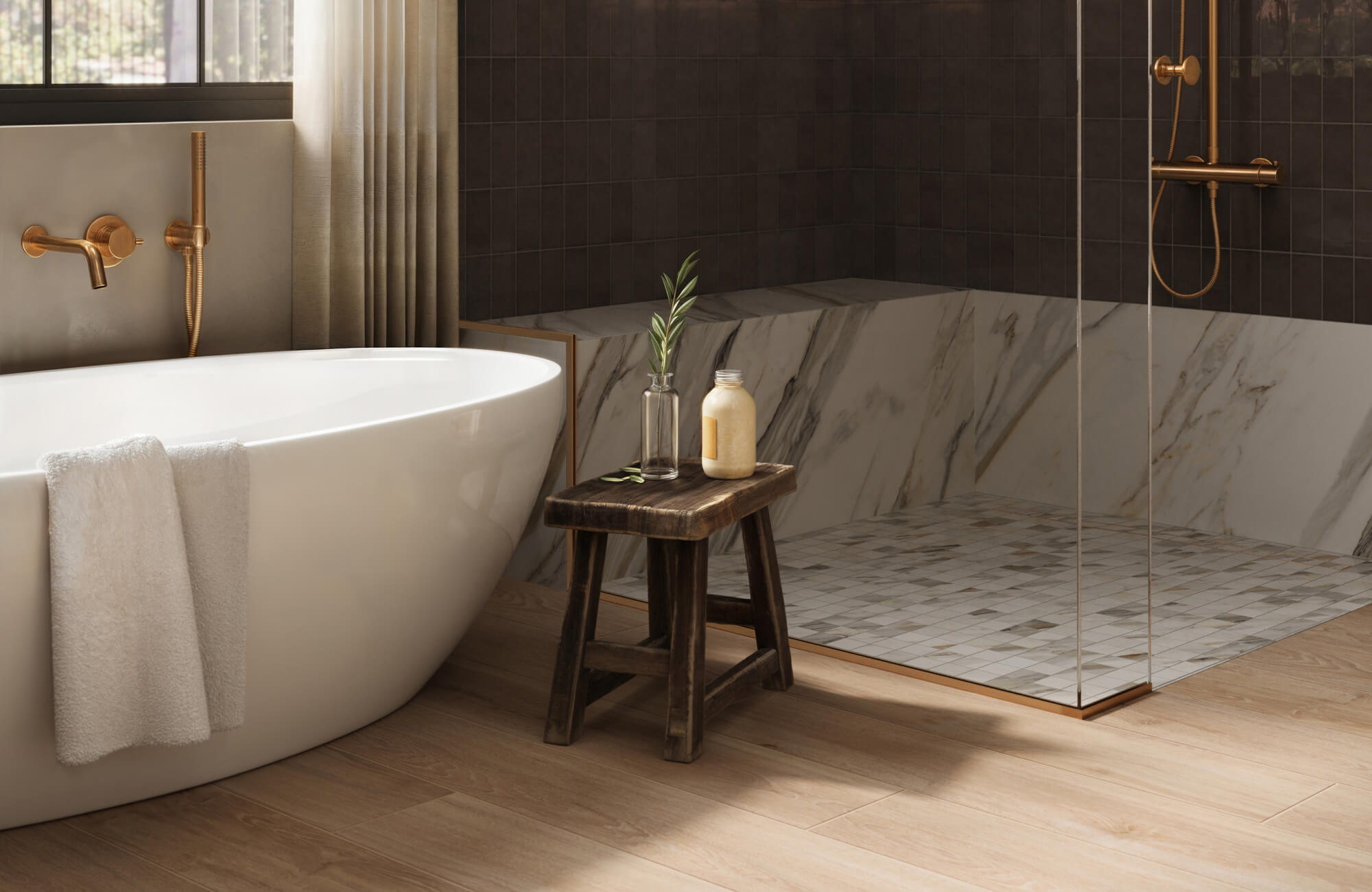 Elegant bathroom with dark subway tile wall, a marble look tile shower base, wood look tile flooring, freestanding tub, and warm brass fixtures for a cozy, luxurious feel.