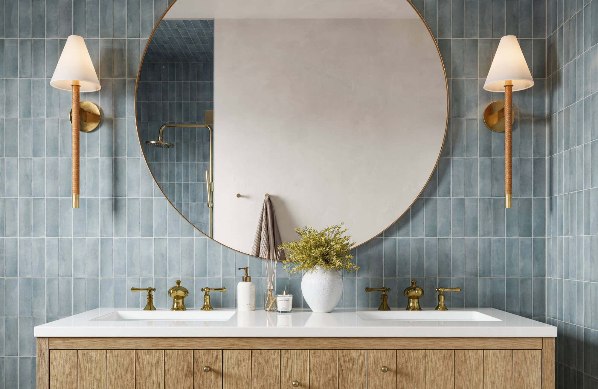 null Chic bathroom with vertical blue ceramic tiles, brass fixtures, and a large round mirror above a dual-sink oak vanity.
