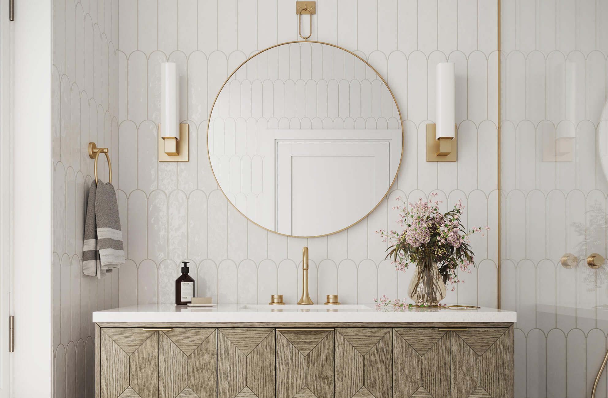 null Elegant bathroom with scalloped white tiles, brushed gold accents, and a chevron wood vanity topped with fresh florals.