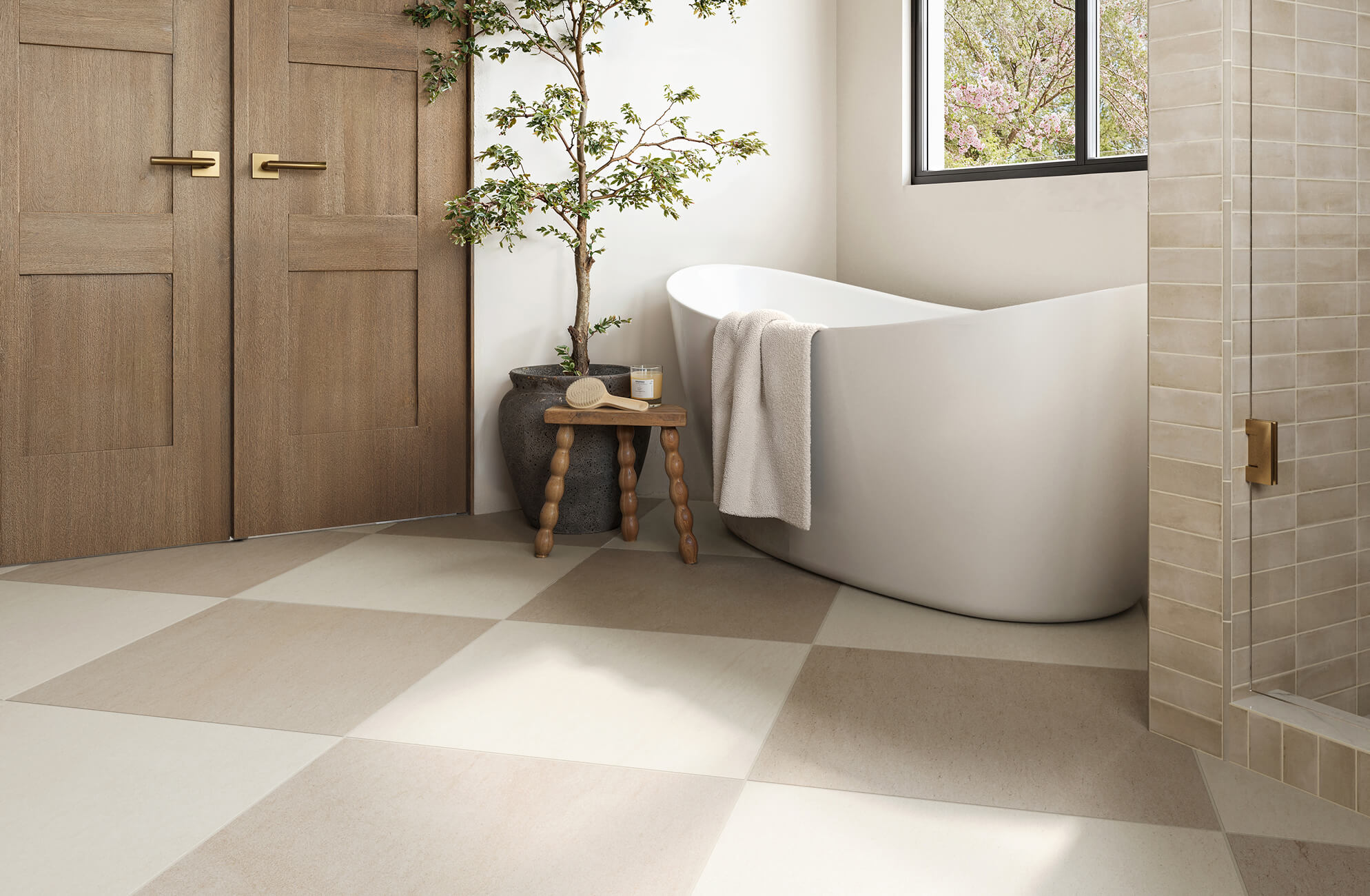 null Serene bathroom with oversized beige checkerboard tiles, a sculptural white tub, and natural wood accents under soft daylight.