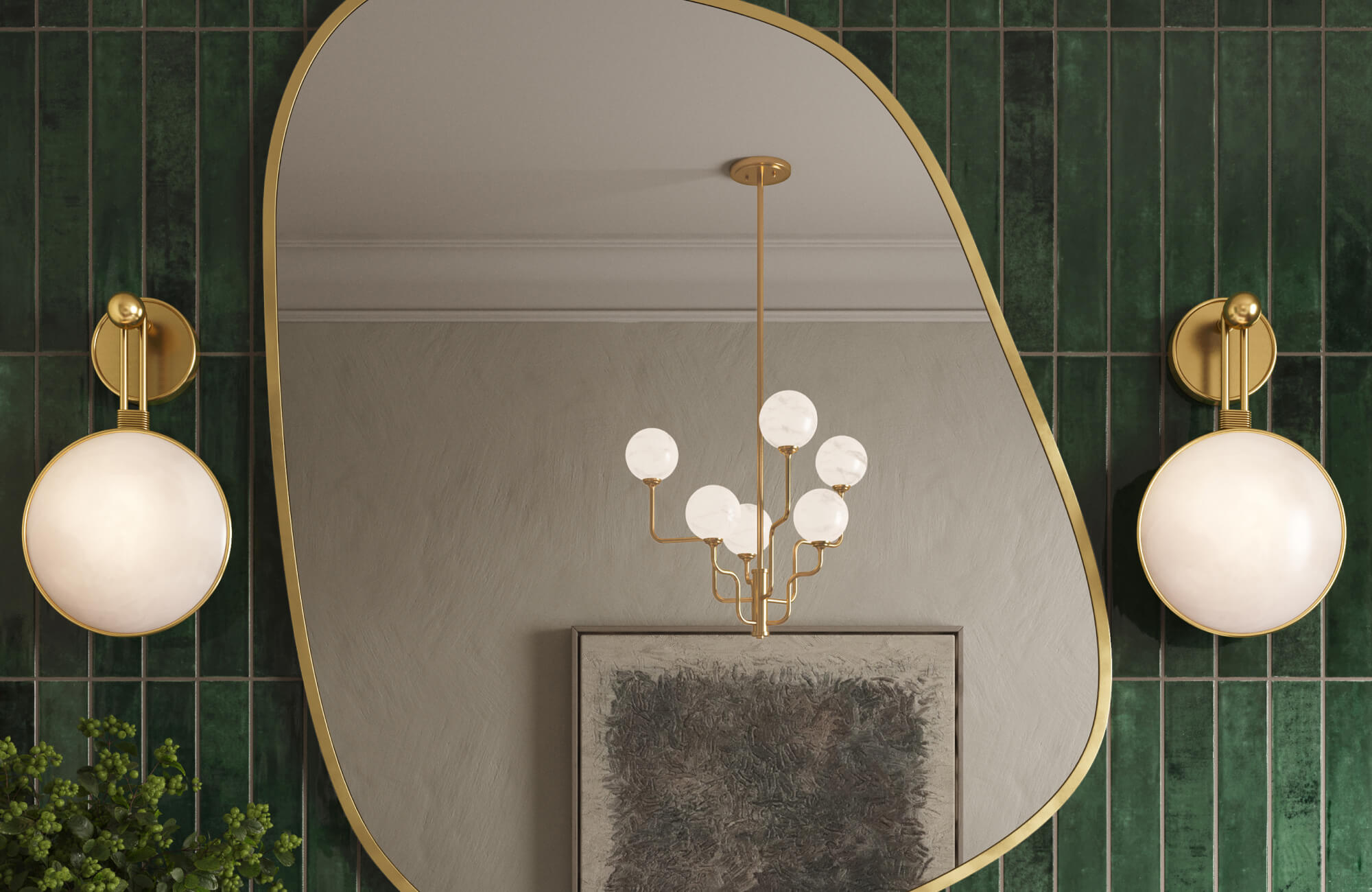 Elegant bathroom vanity featuring a sculptural mirror framed in gold, flanked by spherical brass sconces against deep green vertical tiles for a refined modern look.