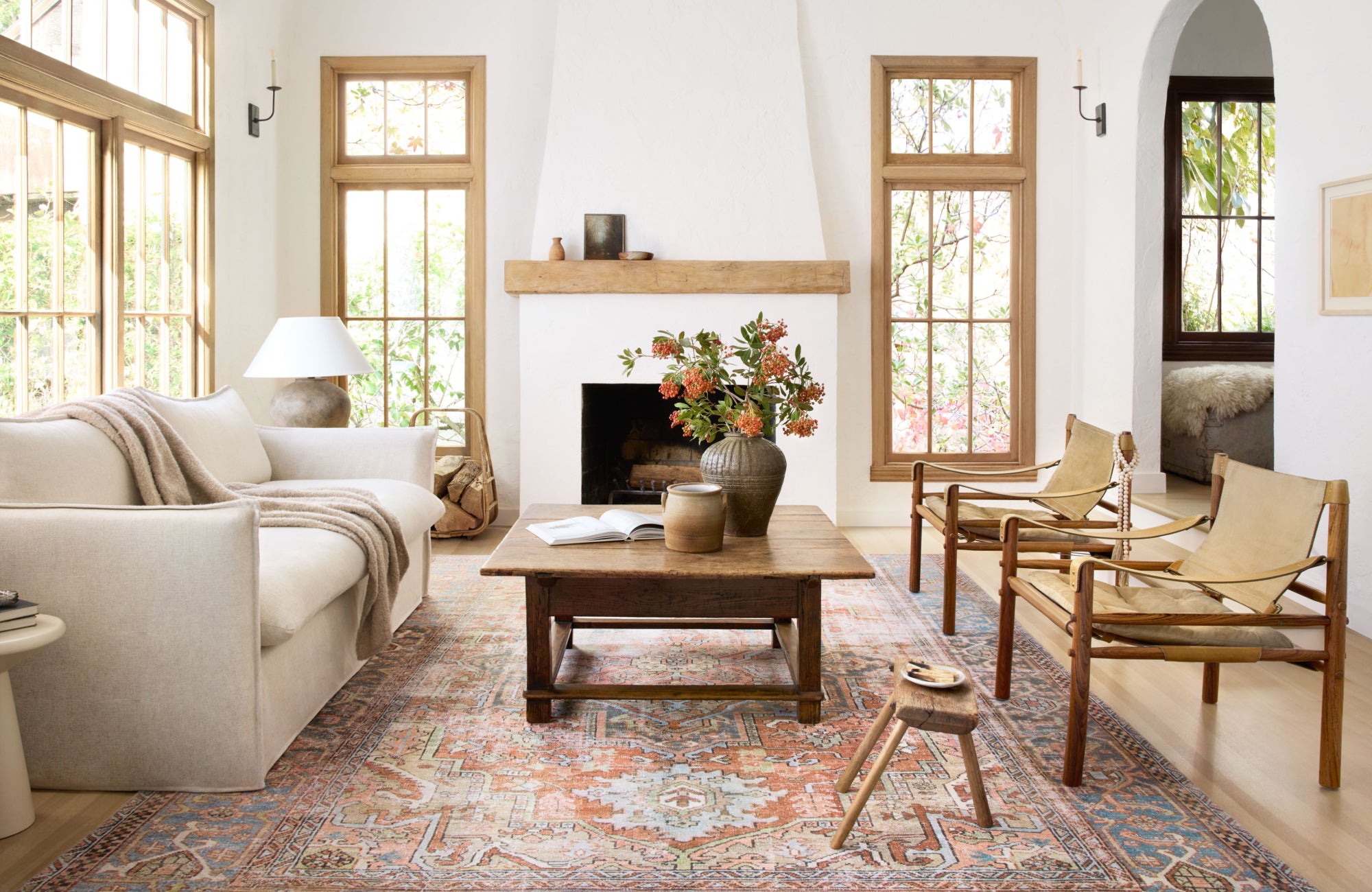 null Bright living room with a traditional patterned rug and wood accents, emphasizing color-rich indoor styling.
