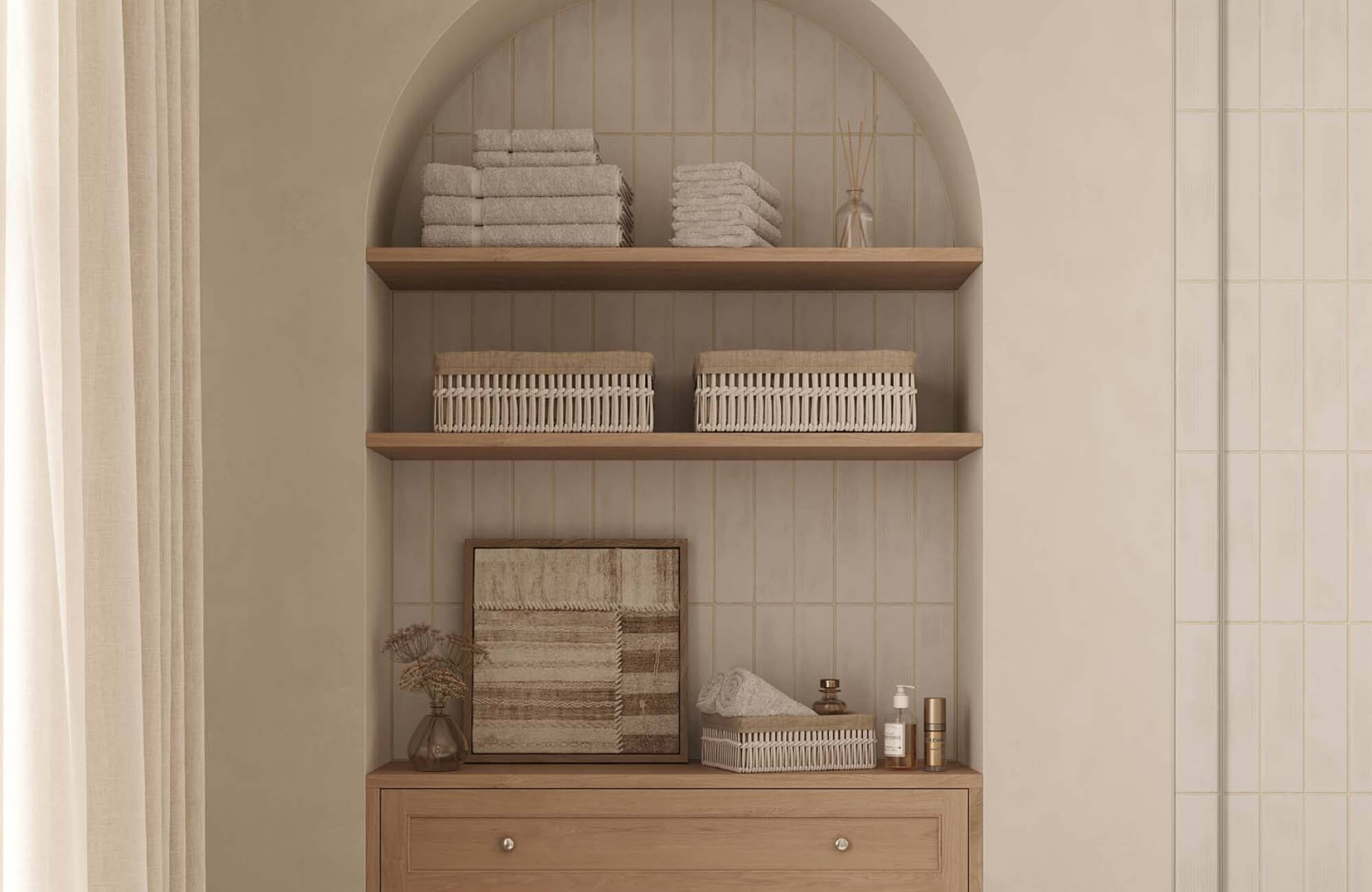null Small neutral-toned artwork layered within arched built-in shelving surrounded by baskets, folded towels, and soft decorative accents in a spa-inspired bathroom