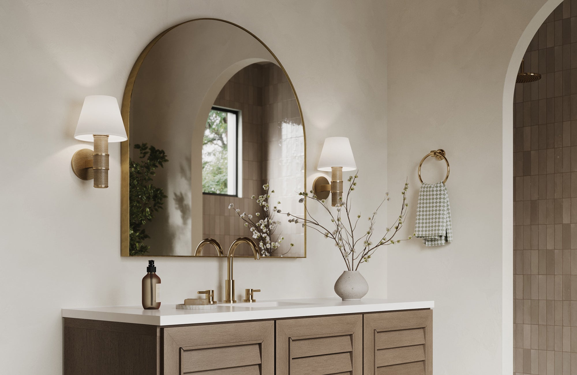 Arched mirror above vanity paired with wall sconces, demonstrating how mirrors align with furniture for harmony.