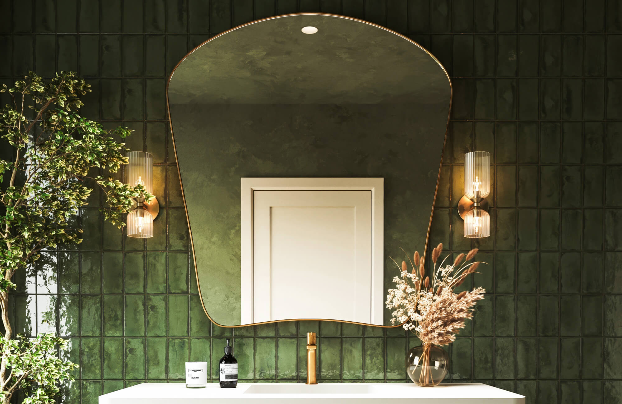 Bathroom vanity wall with glossy green subway tile, sculptural mirror above sink, and decorative sconces on both sides.