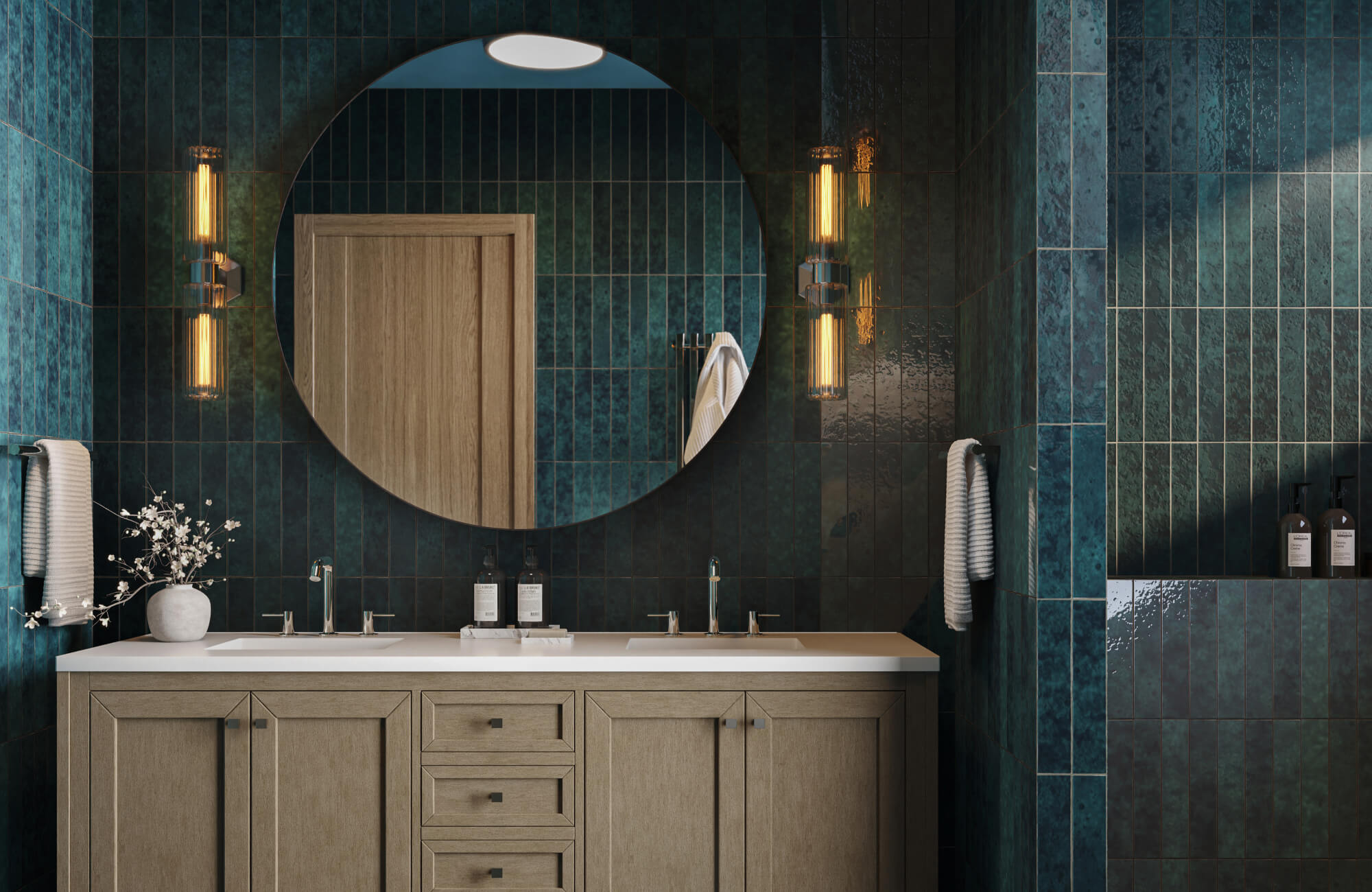 Bathroom vanity wall with glossy blue-green subway tiles, large round mirror, and vertical wall sconces above a double sink cabinet.