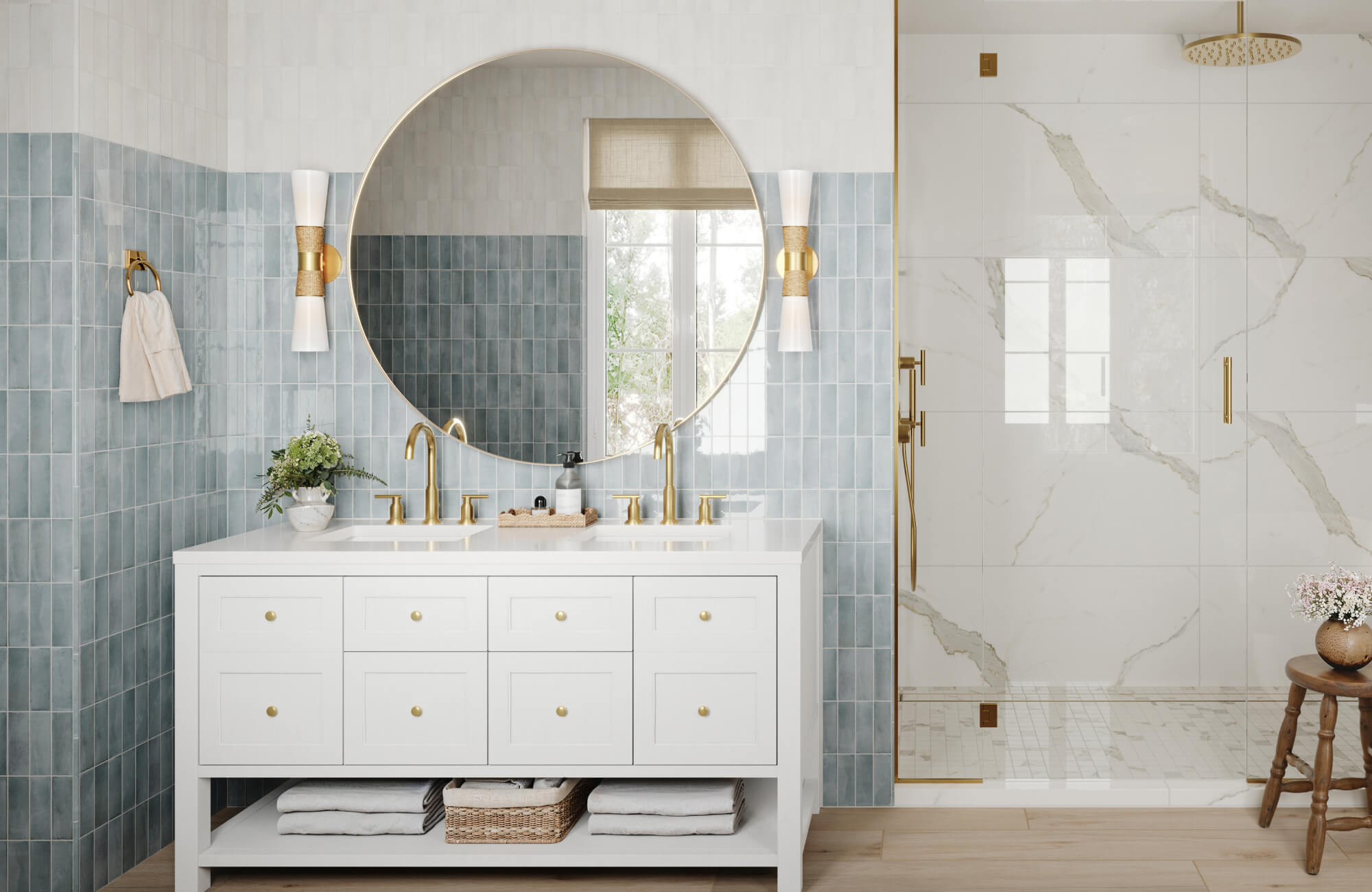 Bright bathroom vanity wall with glossy blue subway tiles, round mirror, brass fixtures, and glass shower enclosure.