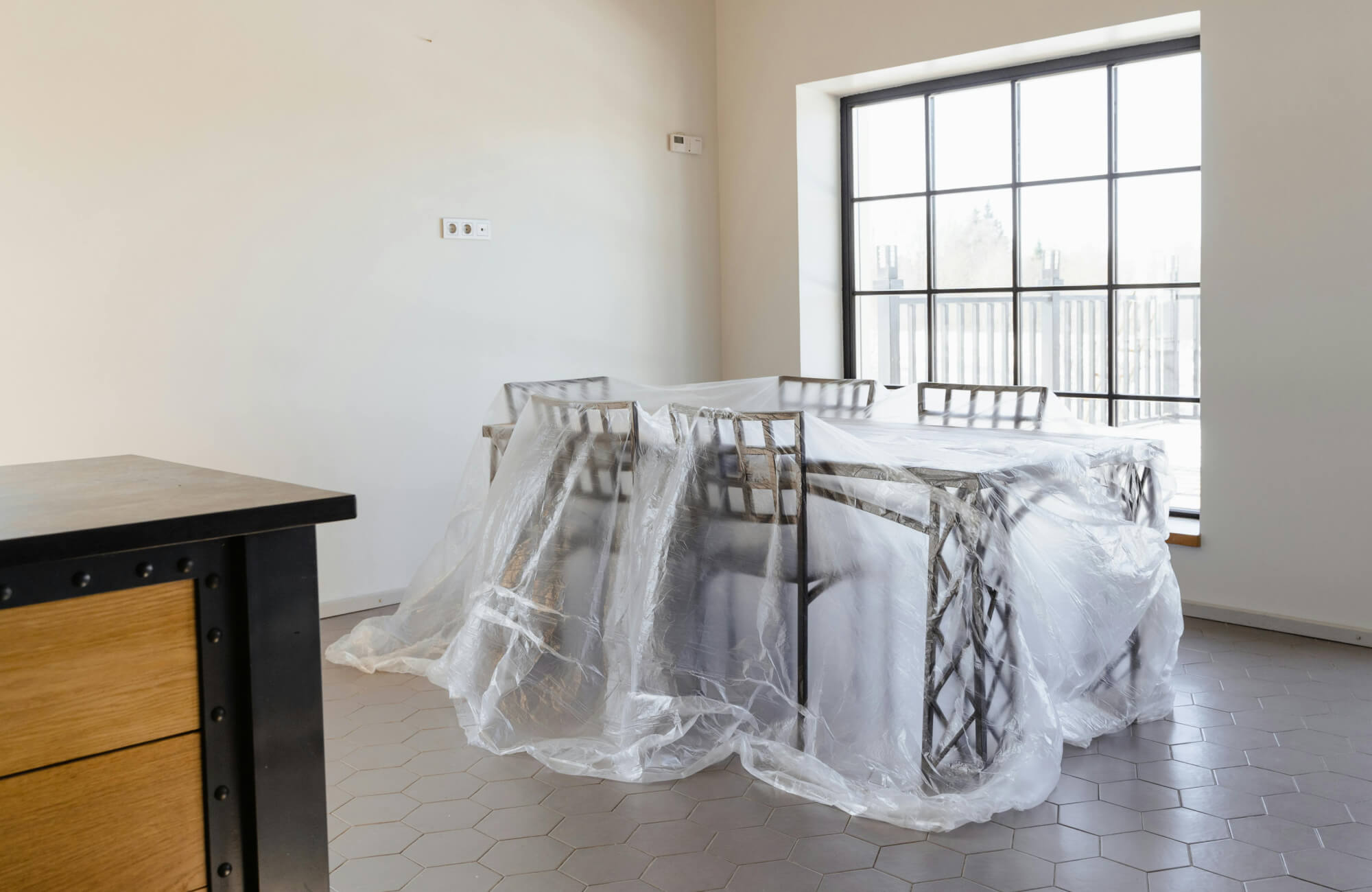 null Home interior covered in protective plastic sheeting to prepare the space for upcoming renovation work.