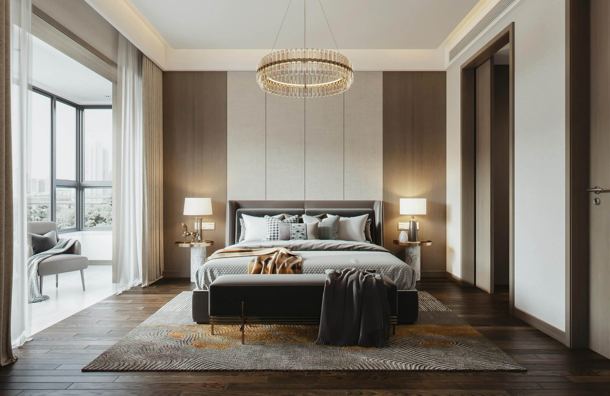 null A stylish bedroom with a statement chandelier, soft neutral tones, and a wide rug that frames the bed and bench, adding texture and warmth to the dark wood flooring.