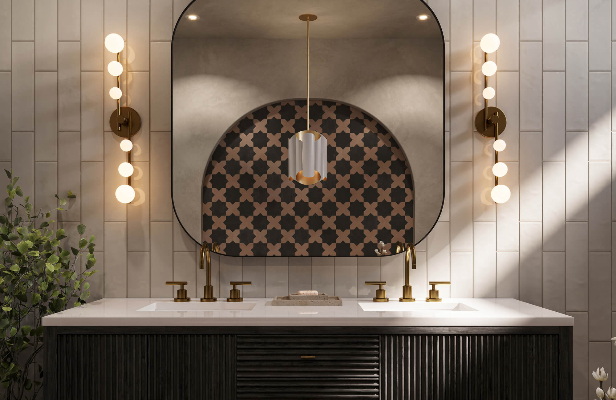 A double-sink bathroom vanity with globe sconces, a large curved mirror, and brass fixtures against patterned tile.
