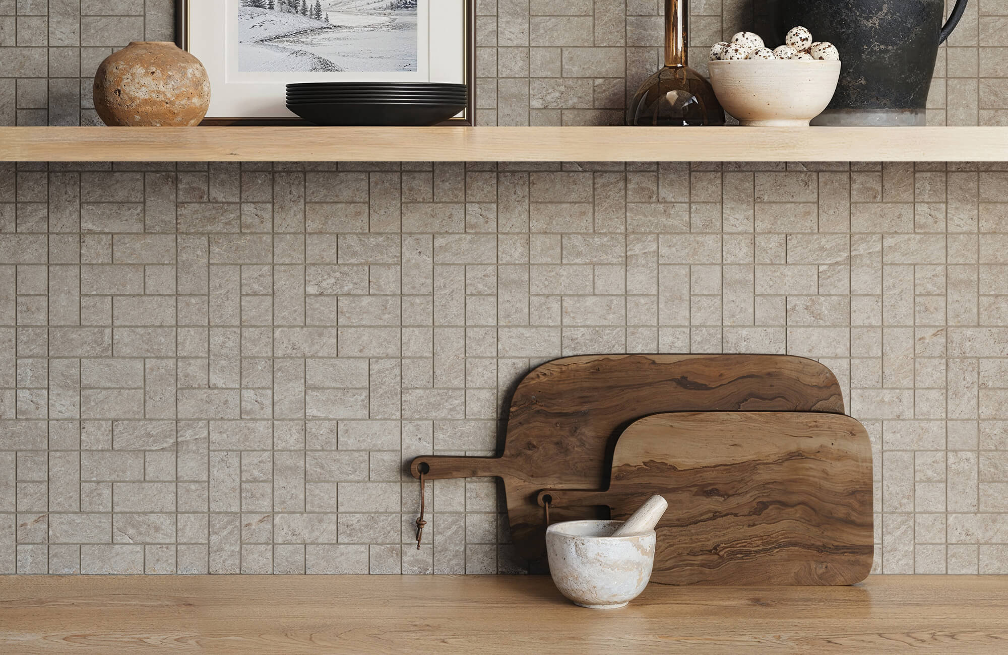null Light gray stone mosaic backsplash with a geometric pattern, wooden cutting boards, and rustic decor on a wooden shelf in a modern kitchen.