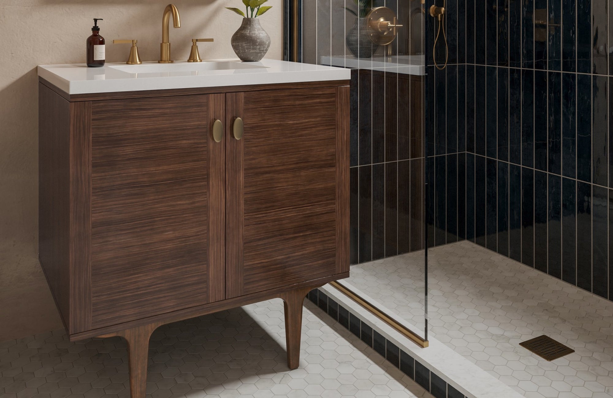 null Elegant bathroom vanity with dark wood finish, gold fixtures, and a white countertop beside a glass shower.