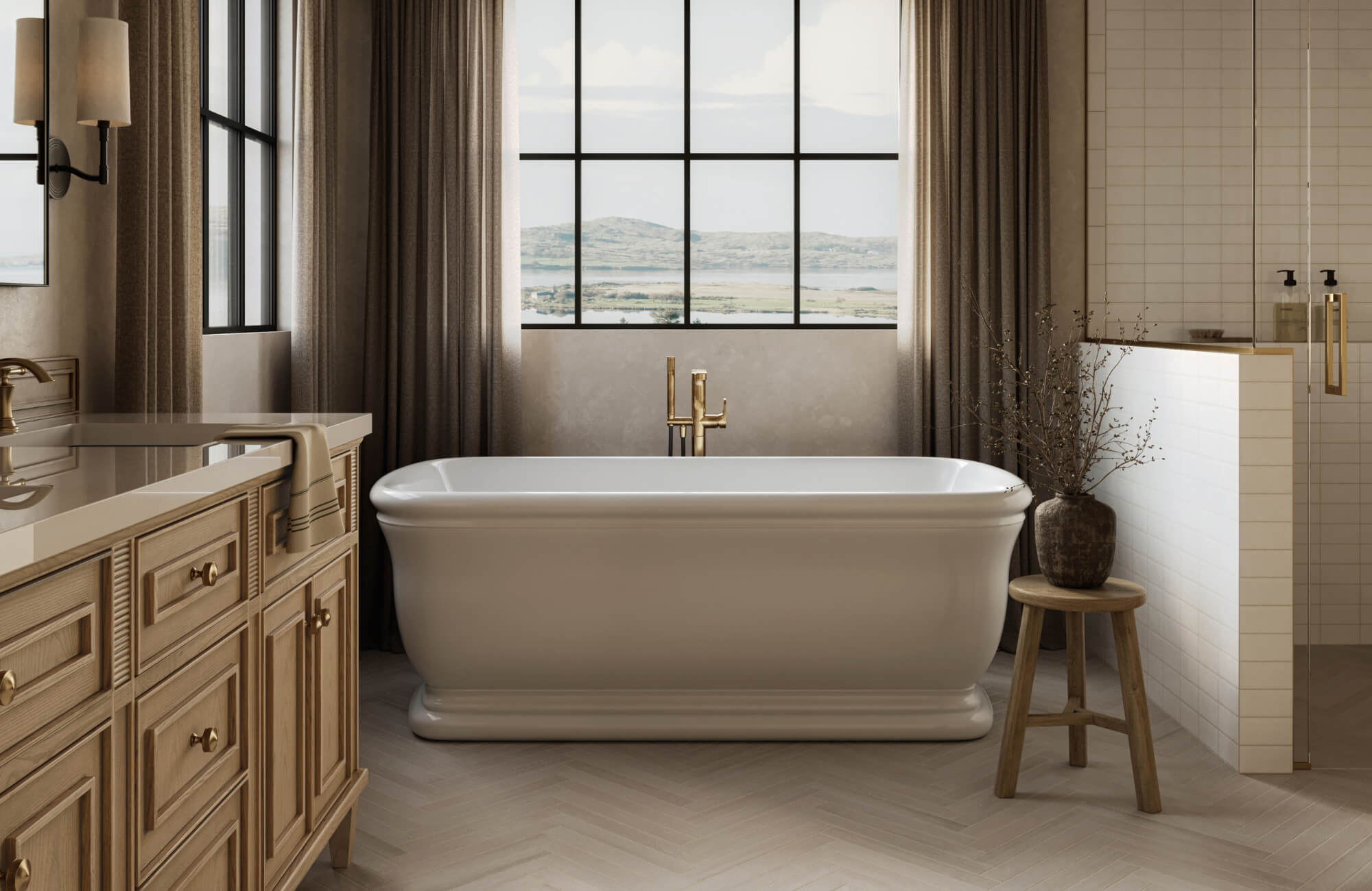 Luxurious bathroom with a freestanding tub, light herringbone ceramic tile flooring, wood vanity, and large windows overlooking a scenic view.