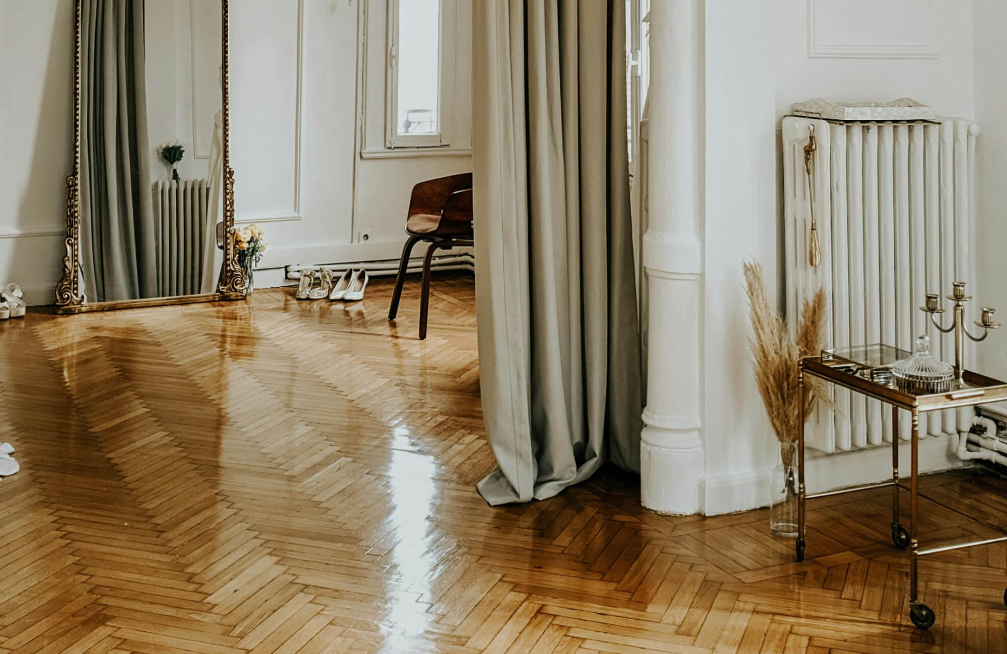 null Elegant living space featuring polished wood flooring in a classic herringbone pattern for timeless appeal.