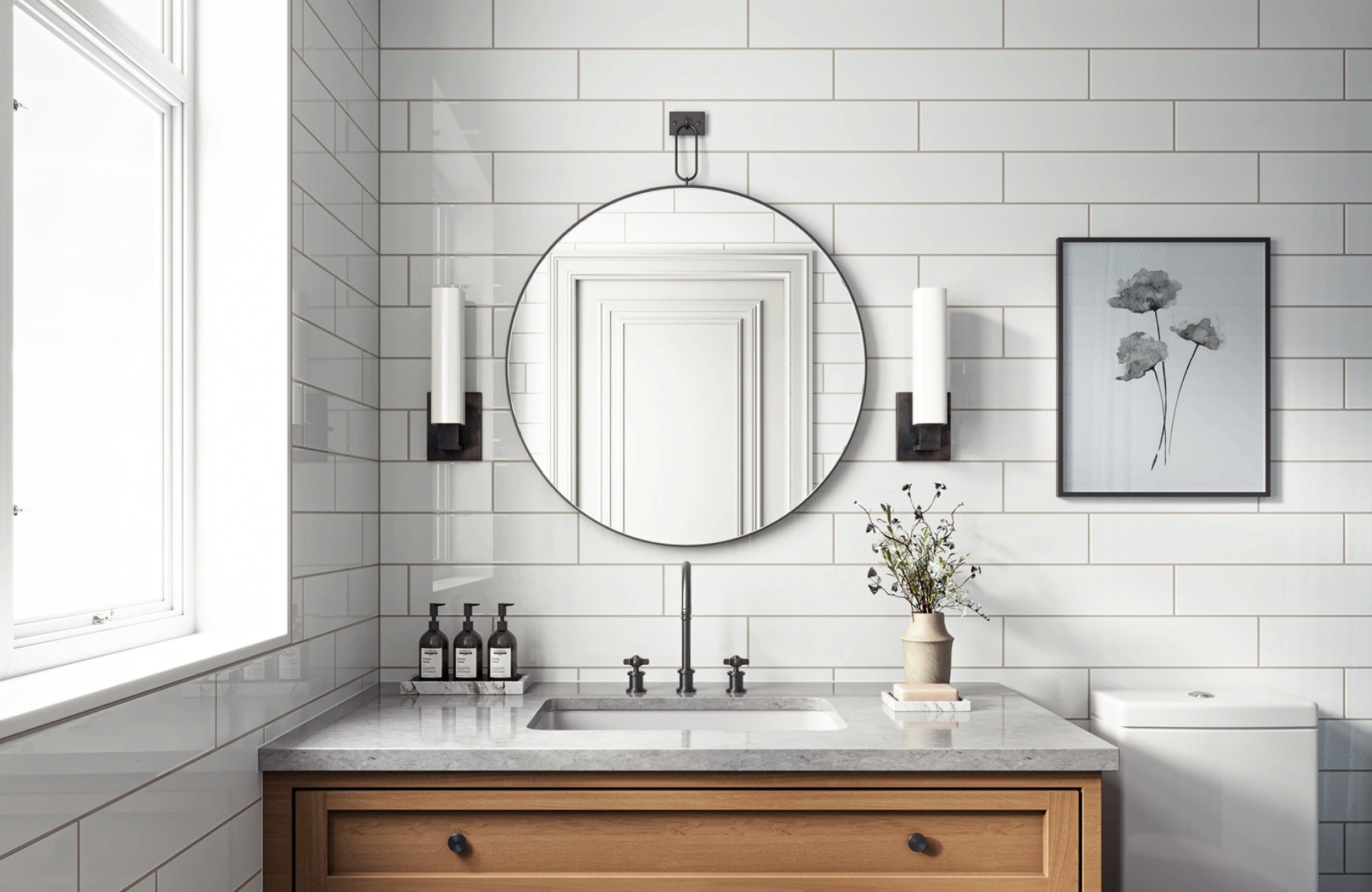 A Compact bathroom with a round mirror between wall sconces and a window.