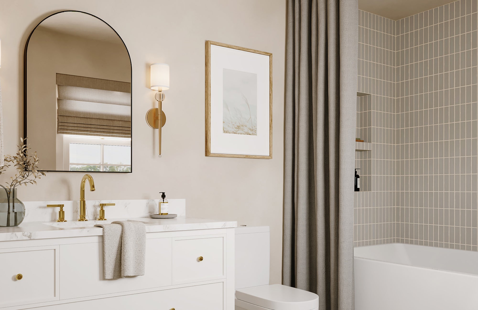 Neutral-toned bathroom with one arched mirror over a white vanity and soft gold fixtures.