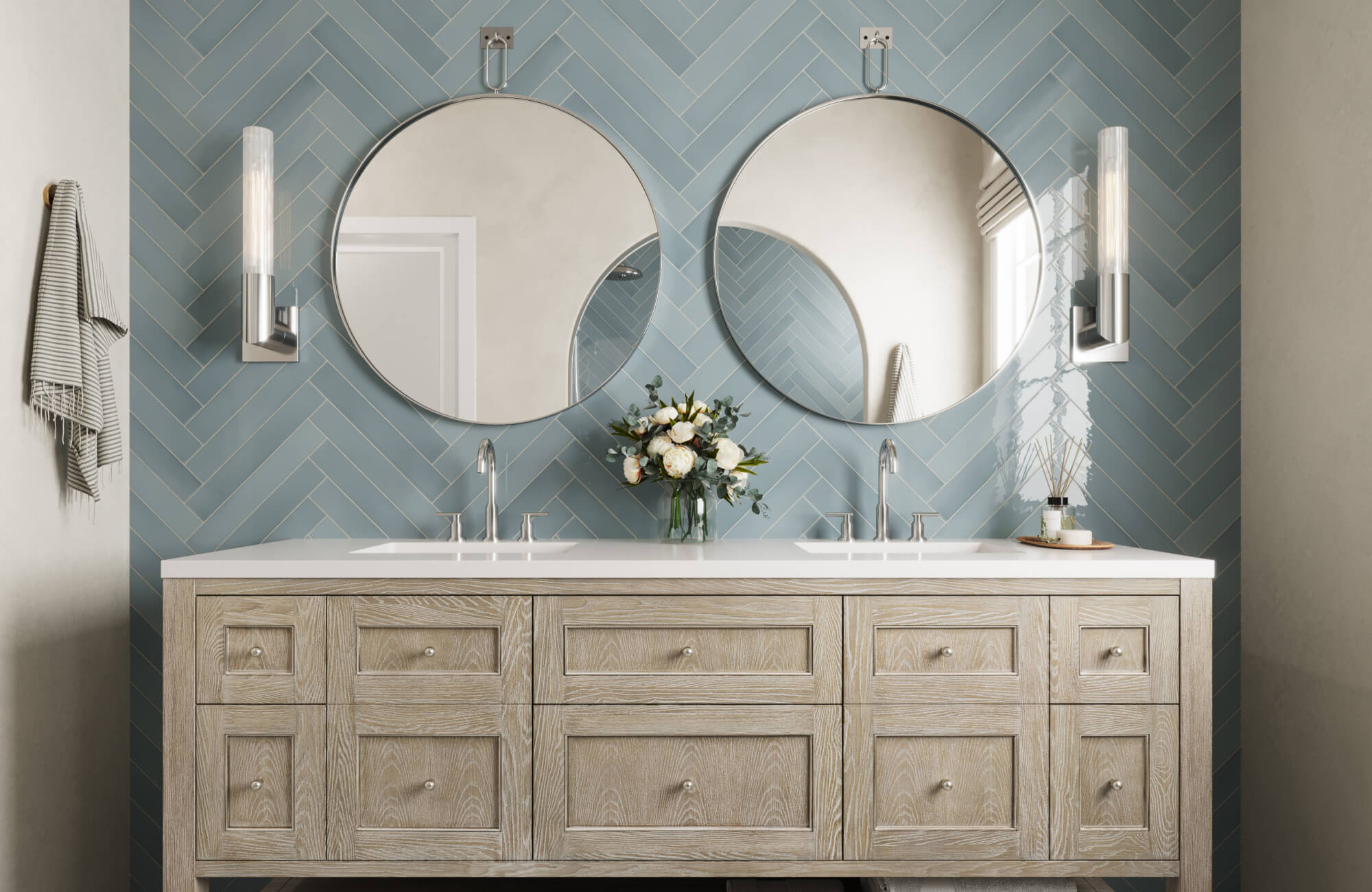 Bathroom featuring dual sinks, circular mirrors, sleek lighting, and a blue tiled accent wall with a wood vanity base.