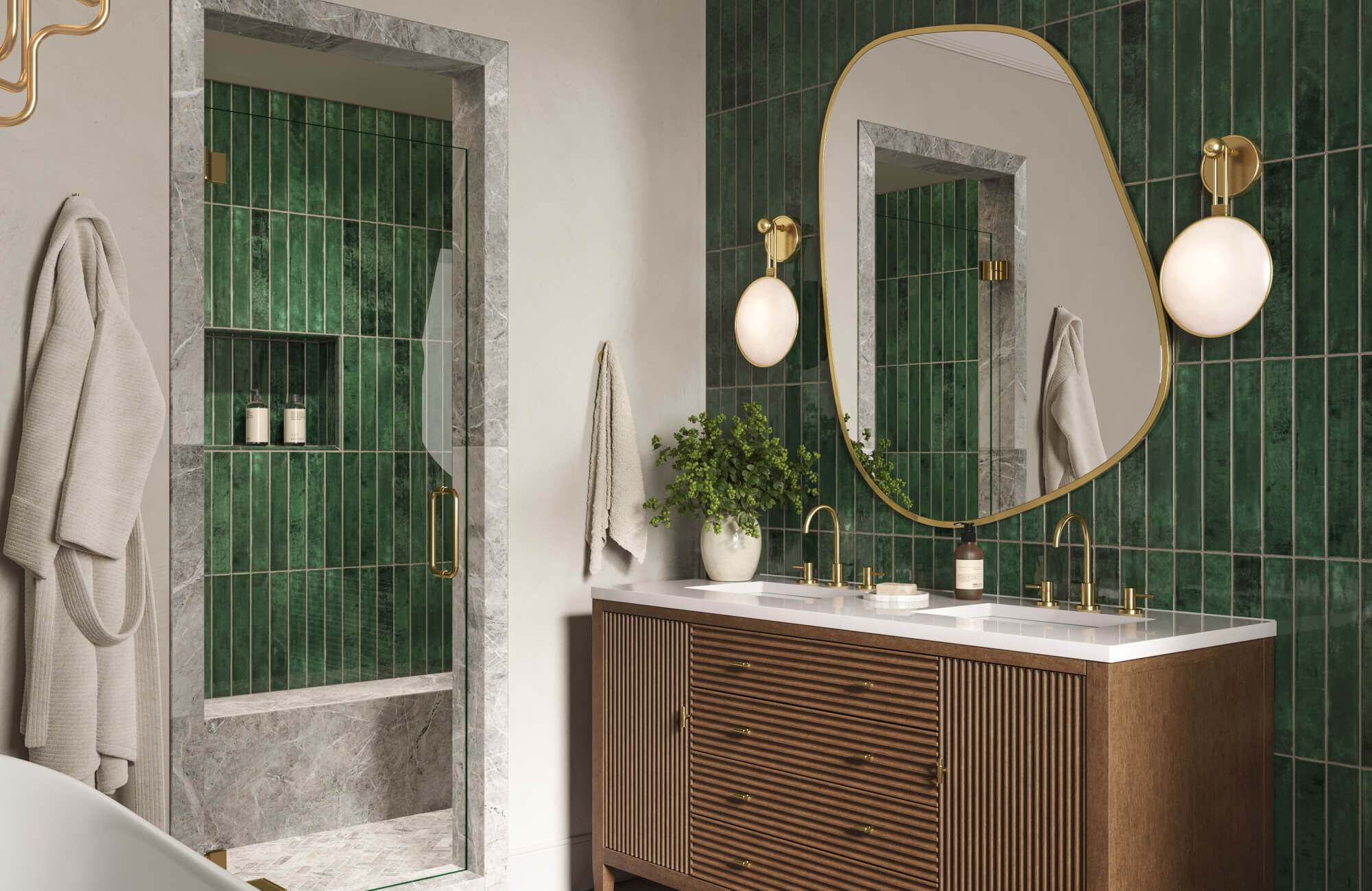 Modern bathroom featuring green vertical tile, marble-trimmed shower, gold fixtures, and globe sconces on each side of the mirror.