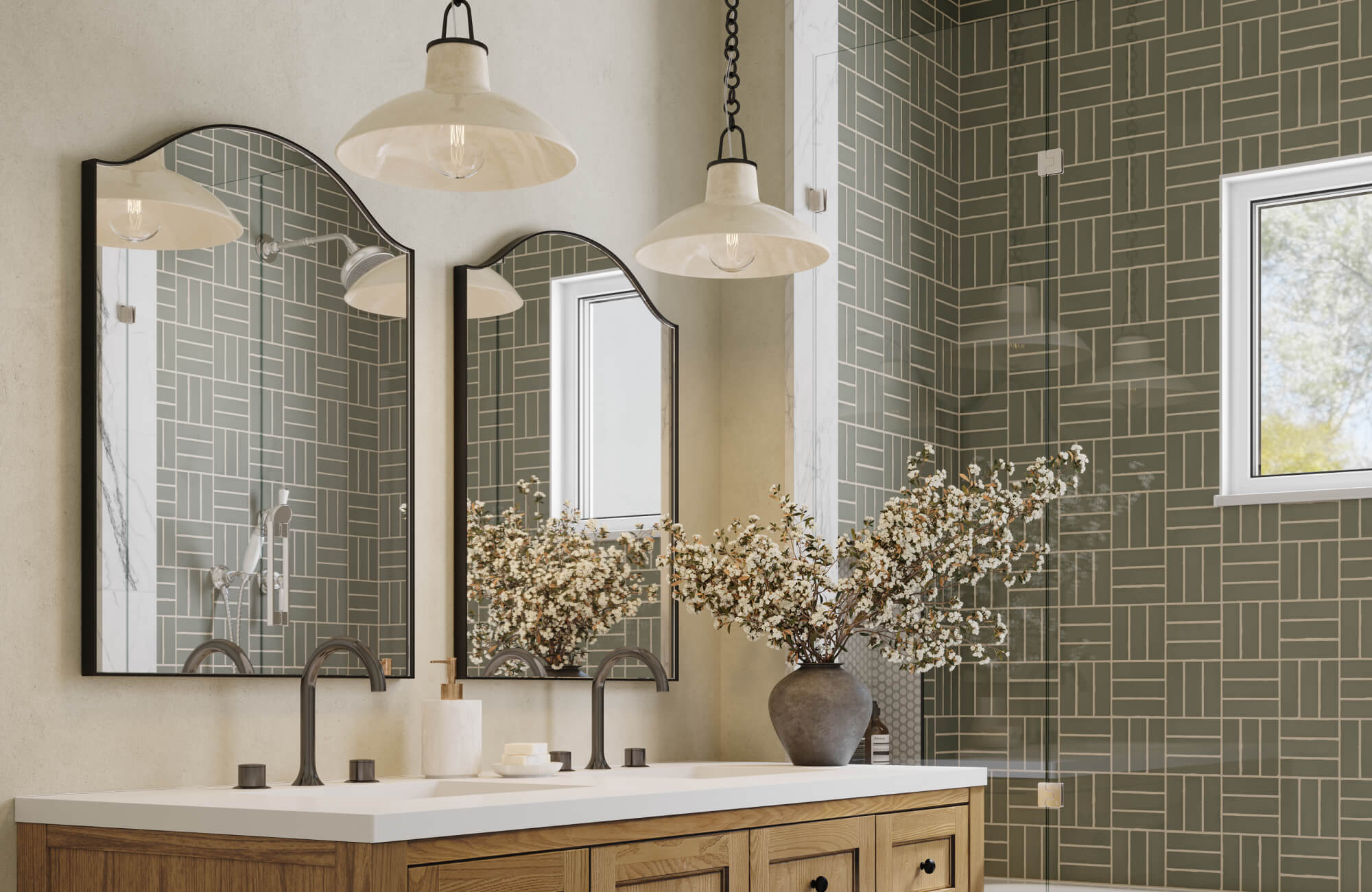 Bathroom with patterned olive-green wall tiles, dual mirrors, and pendant lights above a wood vanity with a white countertop.