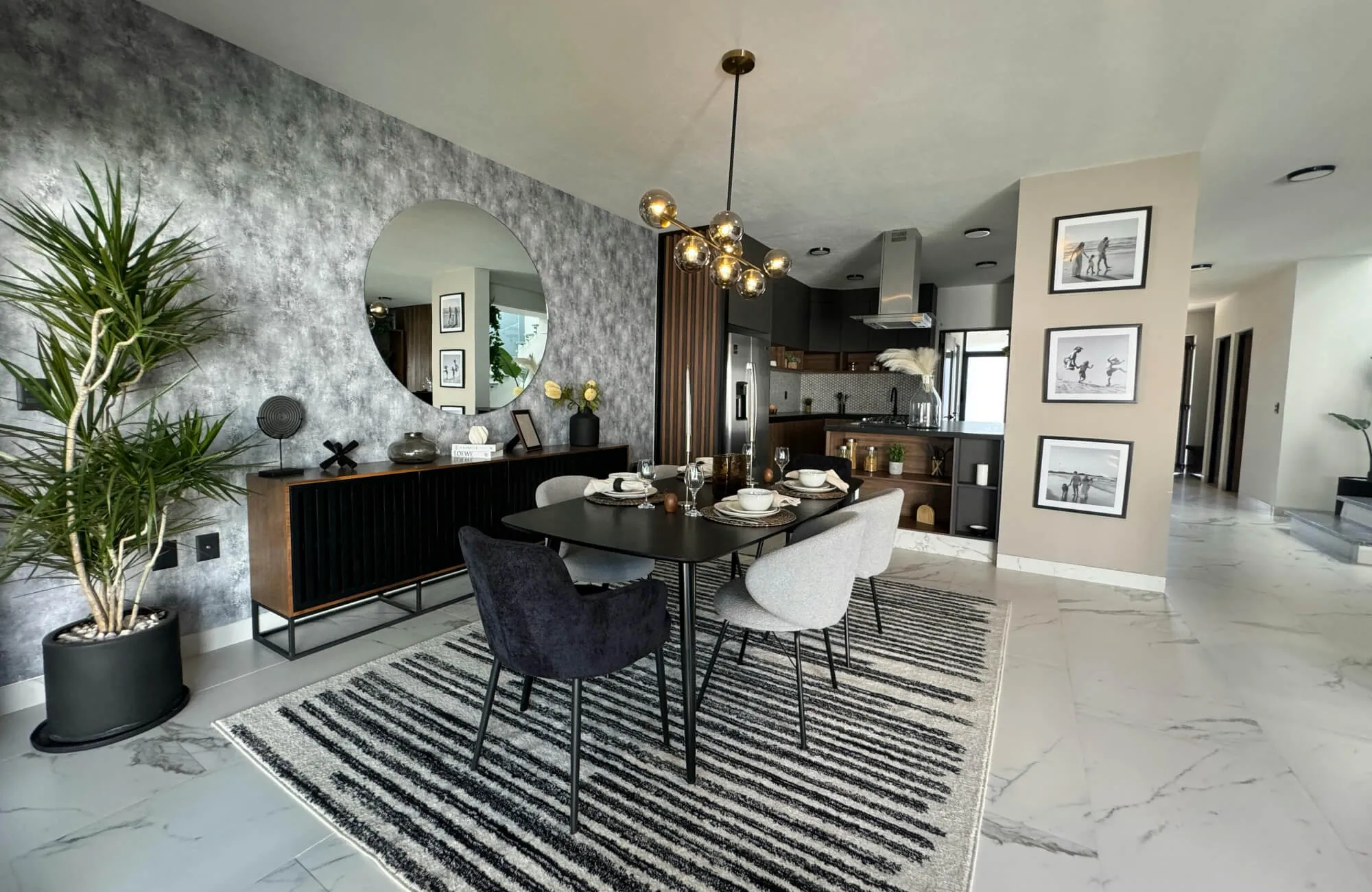 Large round mirror reflecting a modern dining room with a dark table and a patterned rug