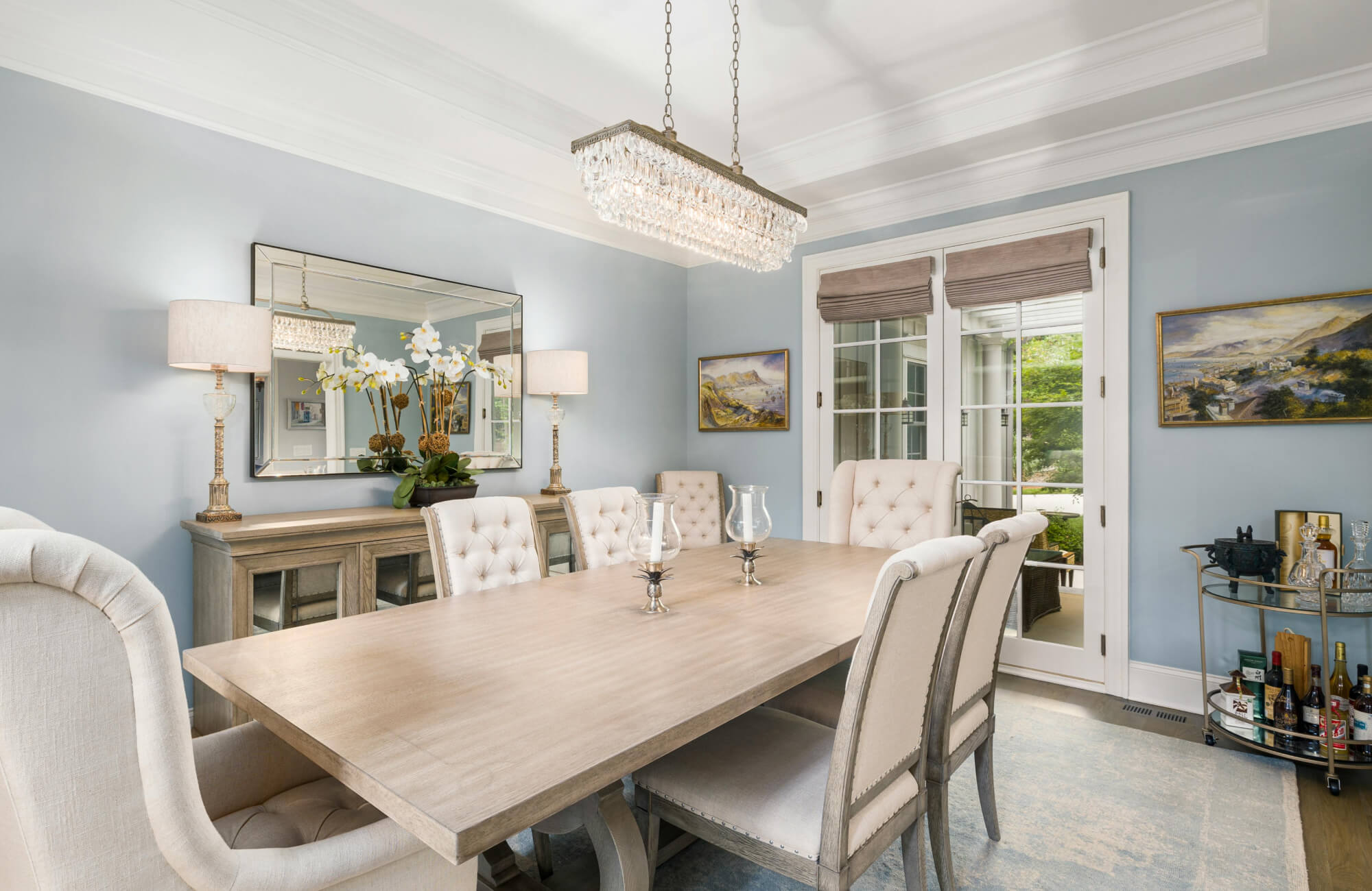 Wide rectangular mirror above sideboard reflecting elegant dining room décor