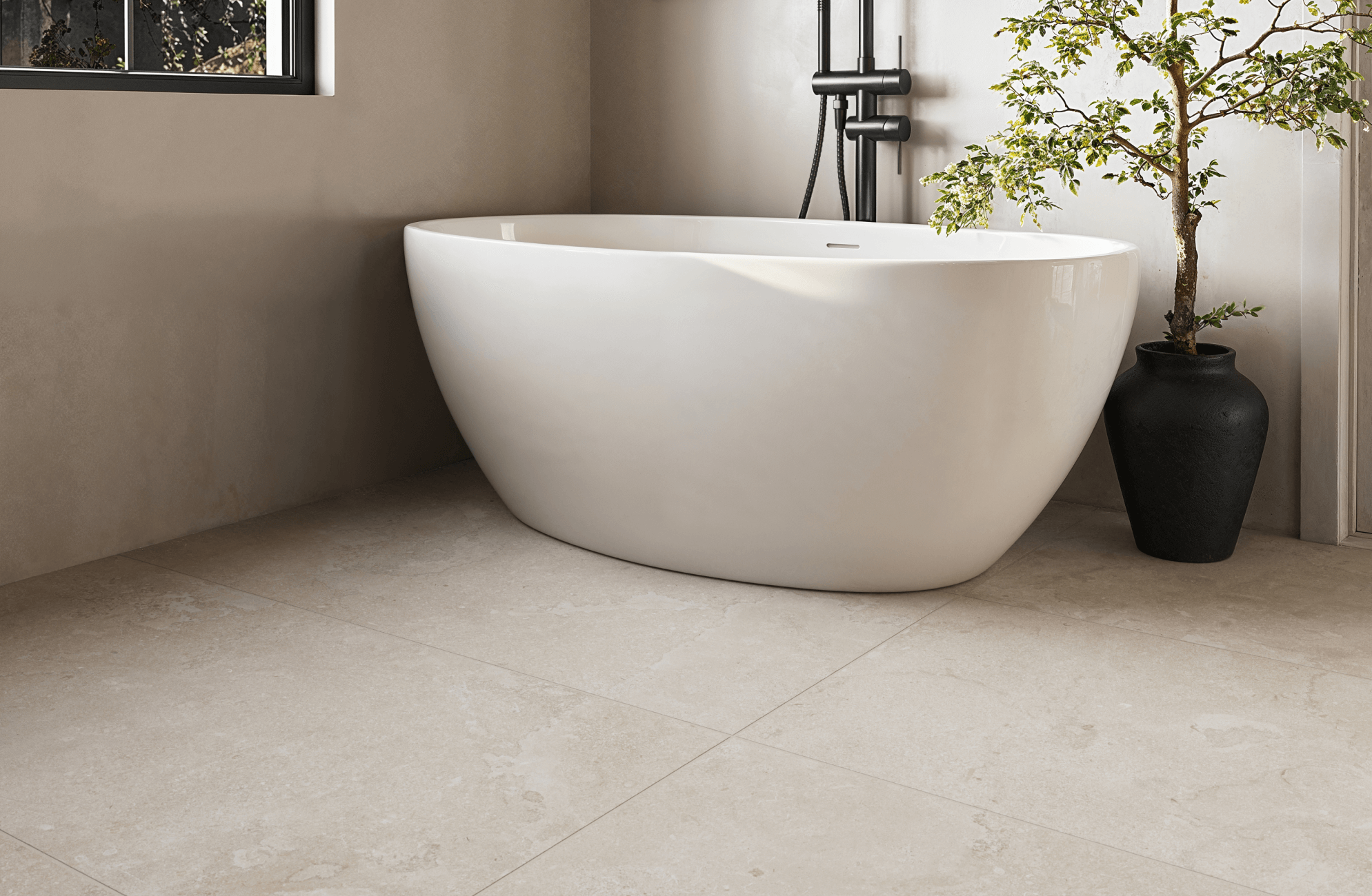 Large floor tiles in a small bathroom with freestanding tub, showcasing big tiles for bathroom floors that create a clean, continuous surface with fewer grout lines.