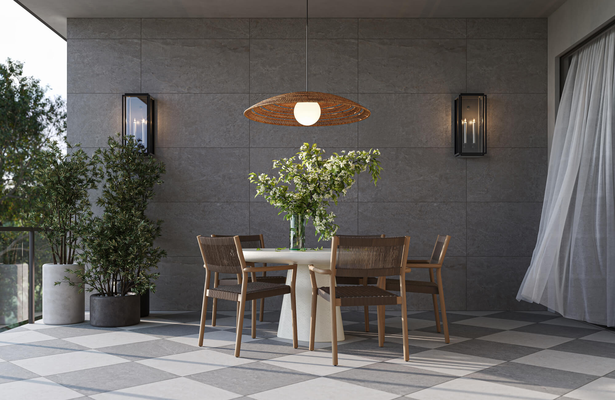 null Large dark gray stone-look outdoor tile creates a clean modern backdrop, paired with wood dining chairs, black lantern sconces, and lush greenery.
