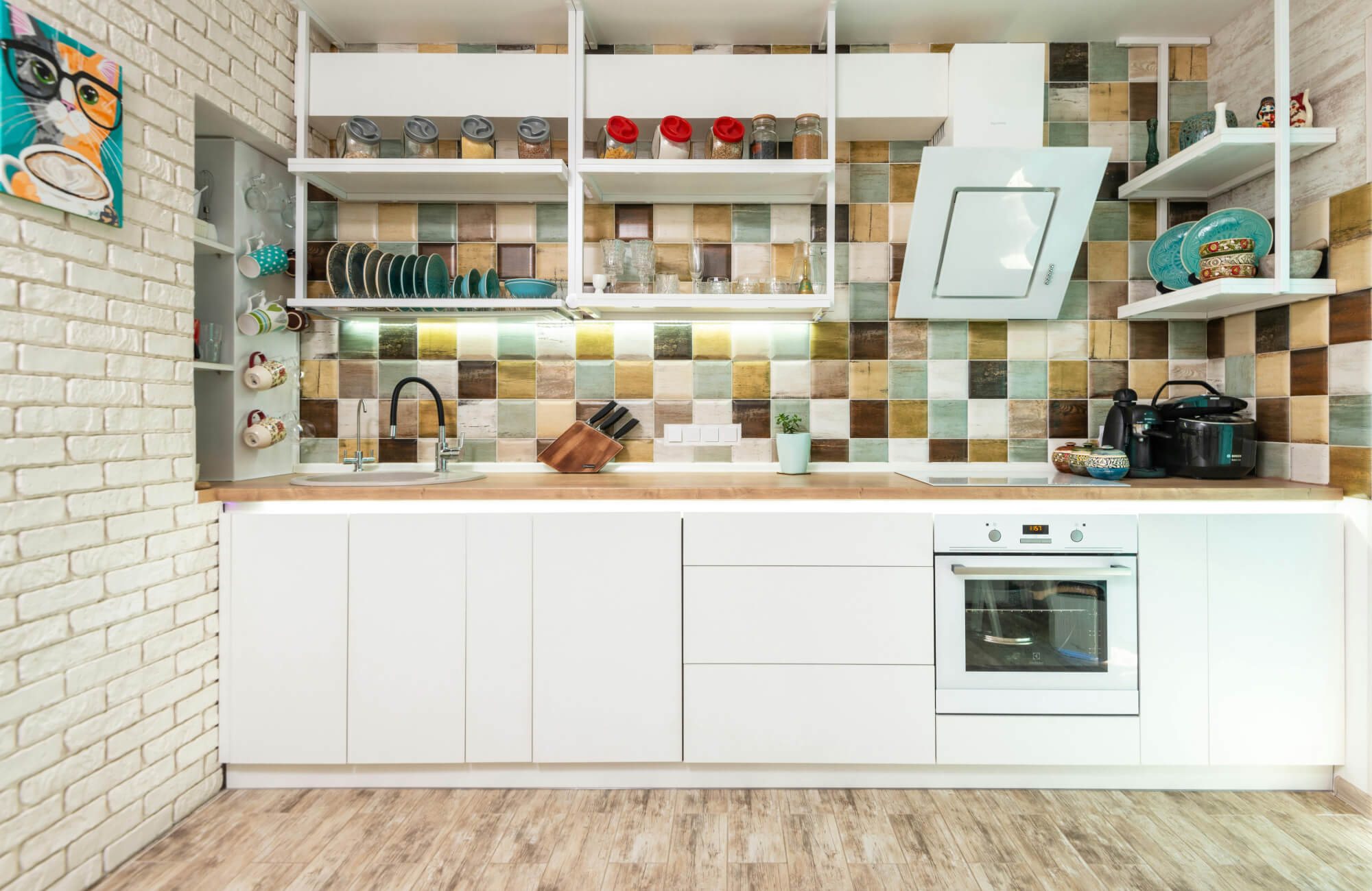 null Bright kitchen with multicolor zellige-look backsplash creating a handcrafted, textured appearance along the walls.