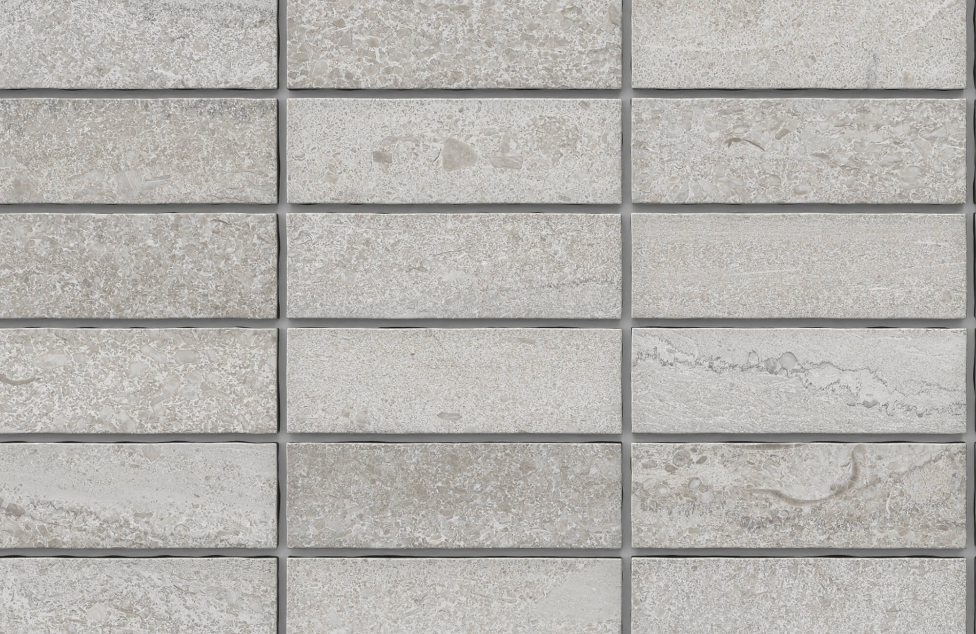 Textured mosaic rectangular tiles in soft greige tones with natural stone detailing for a refined, earthy finish.