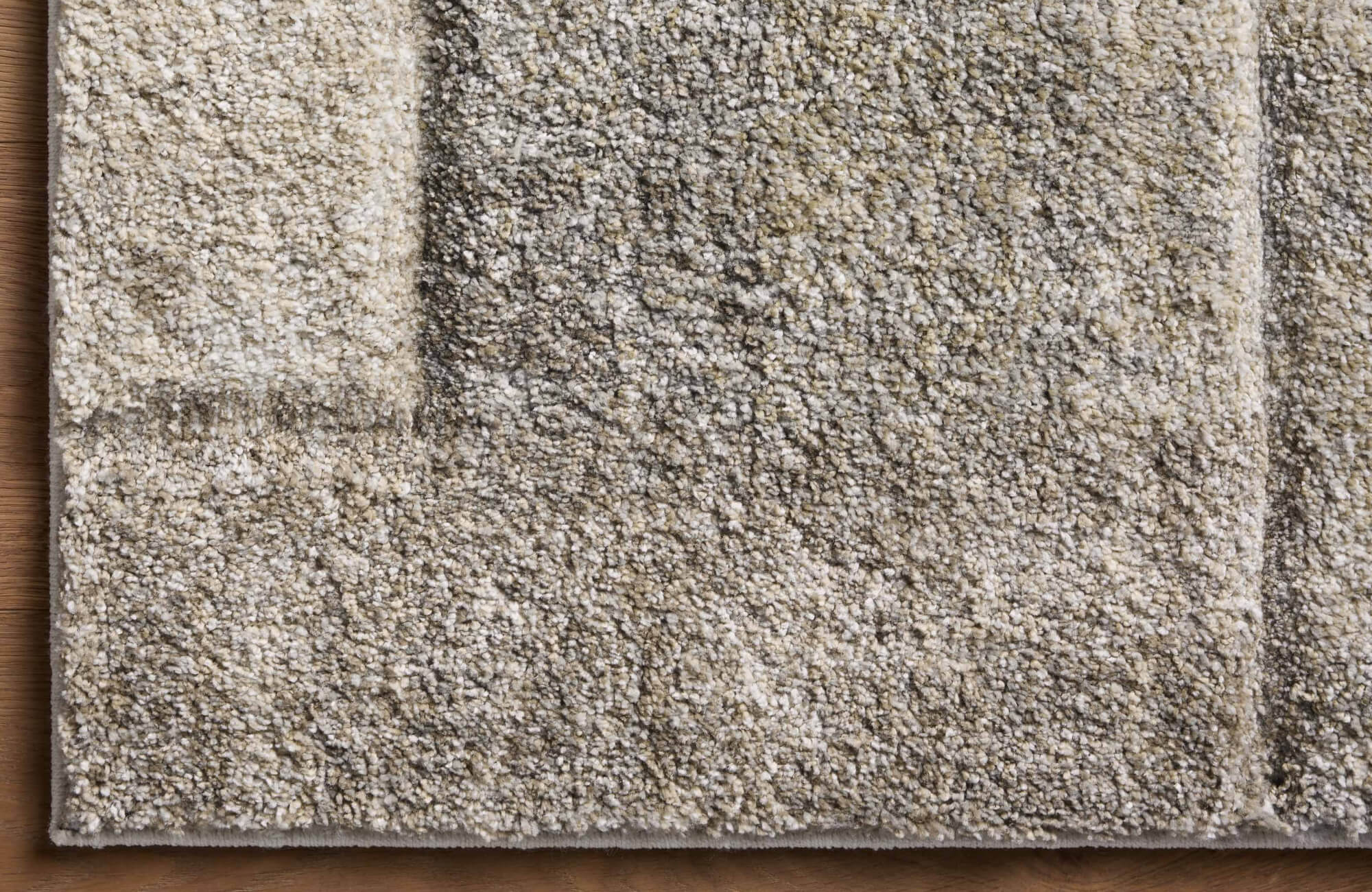 Dense cut-pile polypropylene rug in warm taupe and beige hues with subtle tonal variation, offering a rich, textured look.