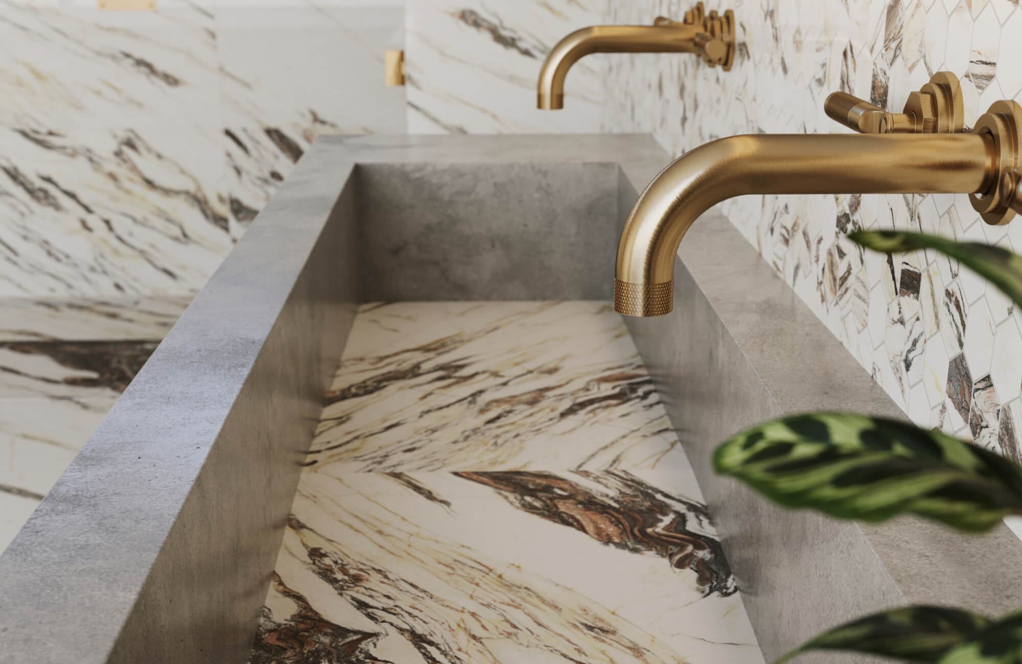 Striking marble-look porcelain tiles with bold veining line a concrete sink, paired with luxe brushed gold faucets.