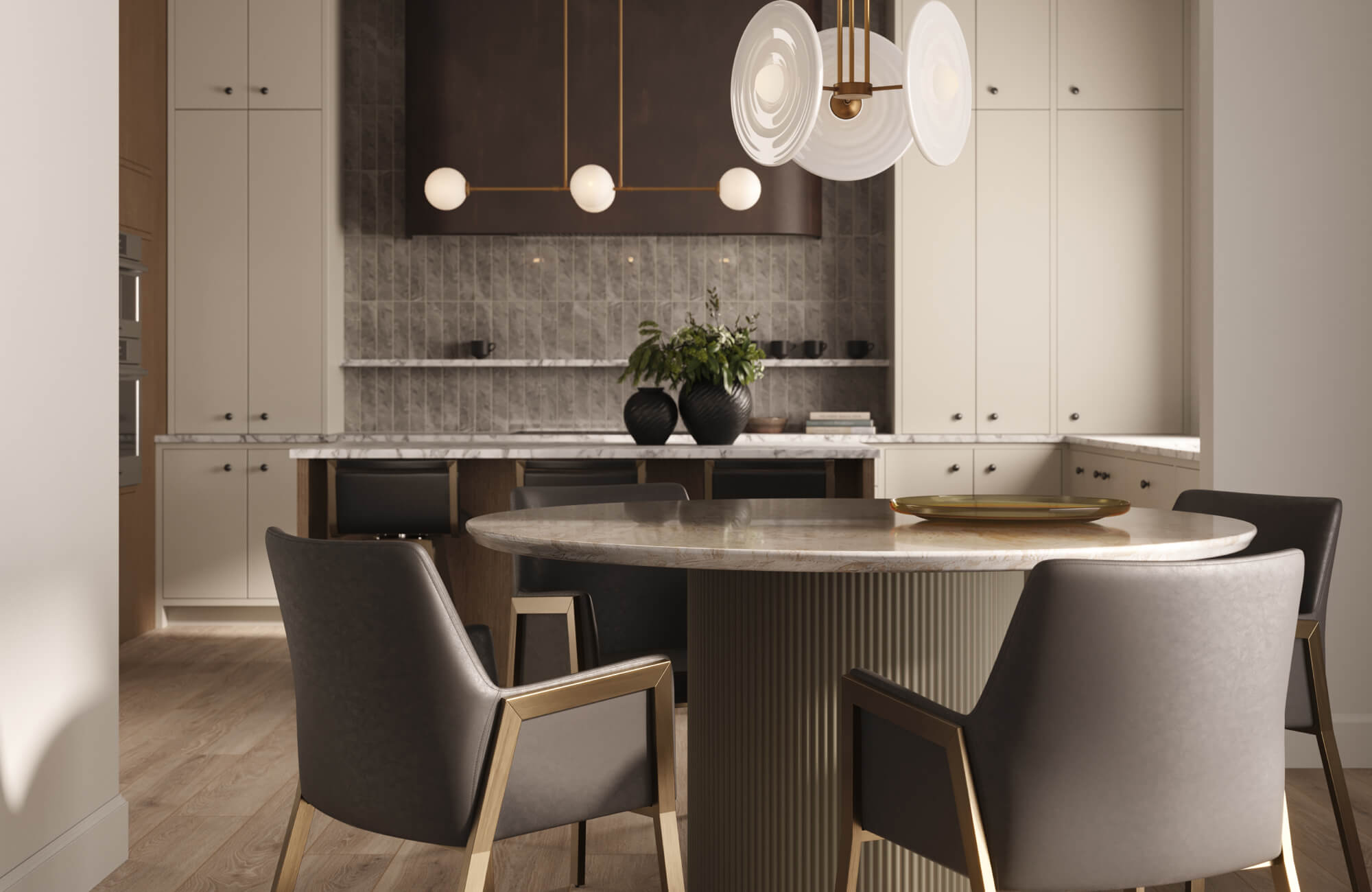 Refined kitchen featuring creamy built-in cabinetry, a marble-topped island with integrated seating, textured tile backsplash, and sculptural brass-accented lighting that creates a warm, modern dining-focused atmosphere.