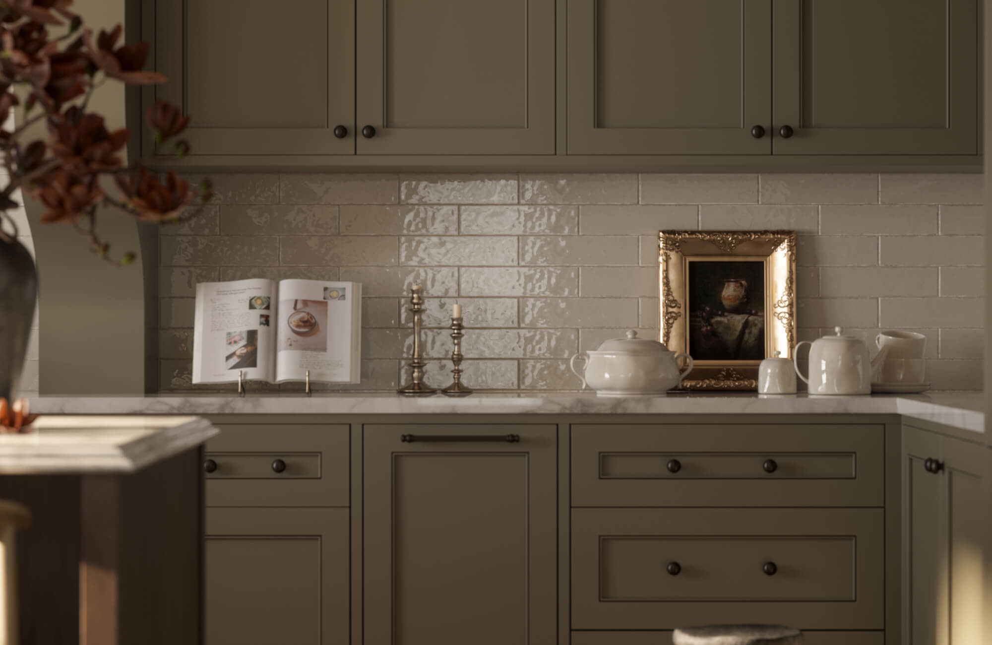 null Traditional kitchen with glossy cream subway tile backsplash, taupe shaker cabinets, marble countertop, and classic decor accents including candlesticks and framed artwork.
