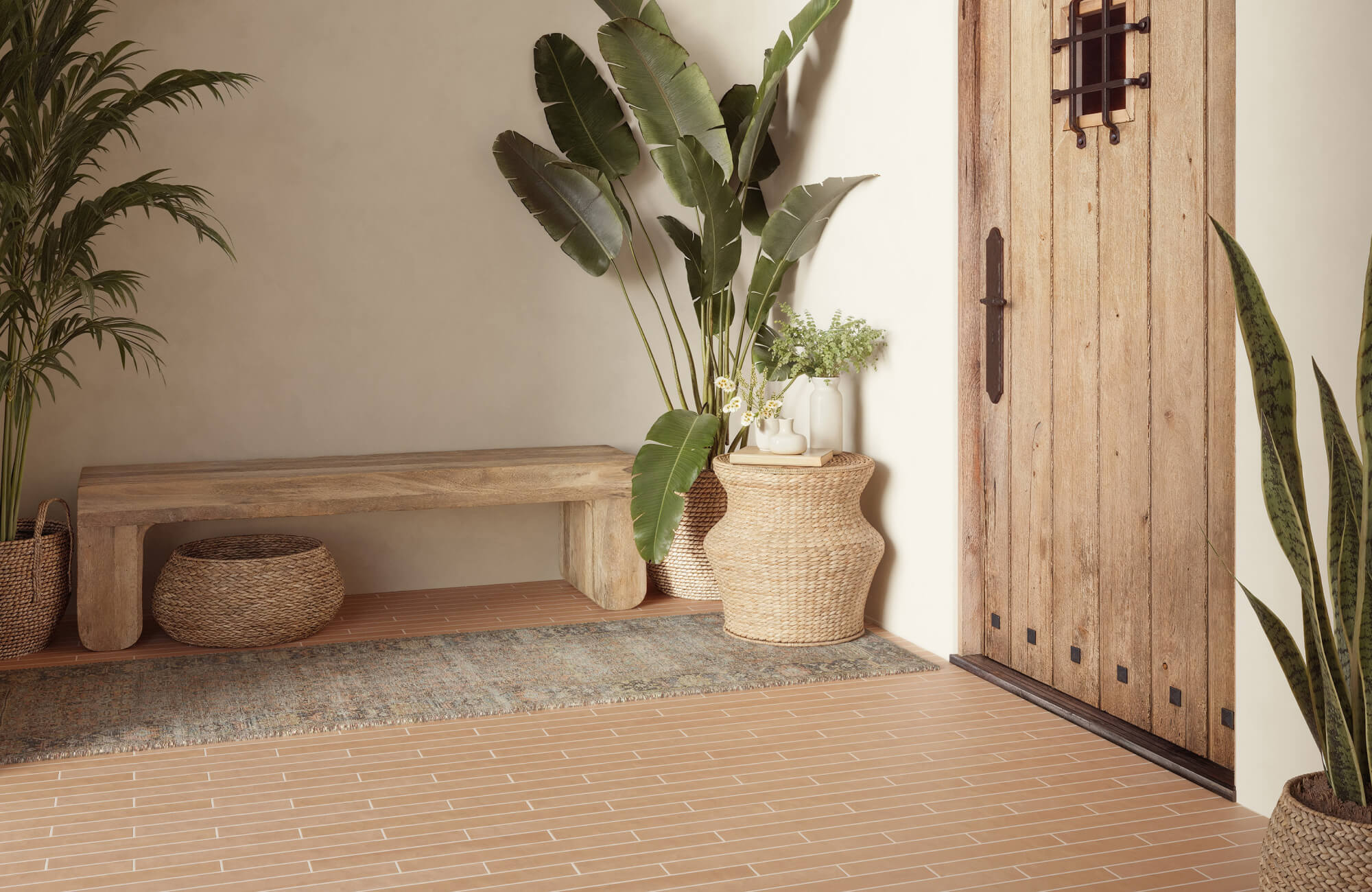 Entryway with dark-toned runner rug on terracotta tile, showing how dark rugs enhance warmth and contrast in small spaces
