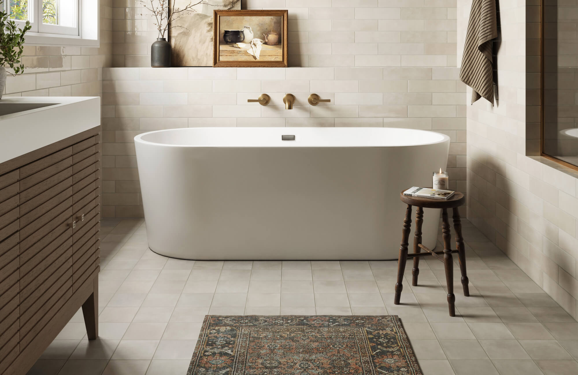 null Calm, refined modern bathroom with creamy subway wall tiles, softly toned square floor tiles, a sculptural freestanding tub, warm brass fixtures, and understated wood cabinetry.