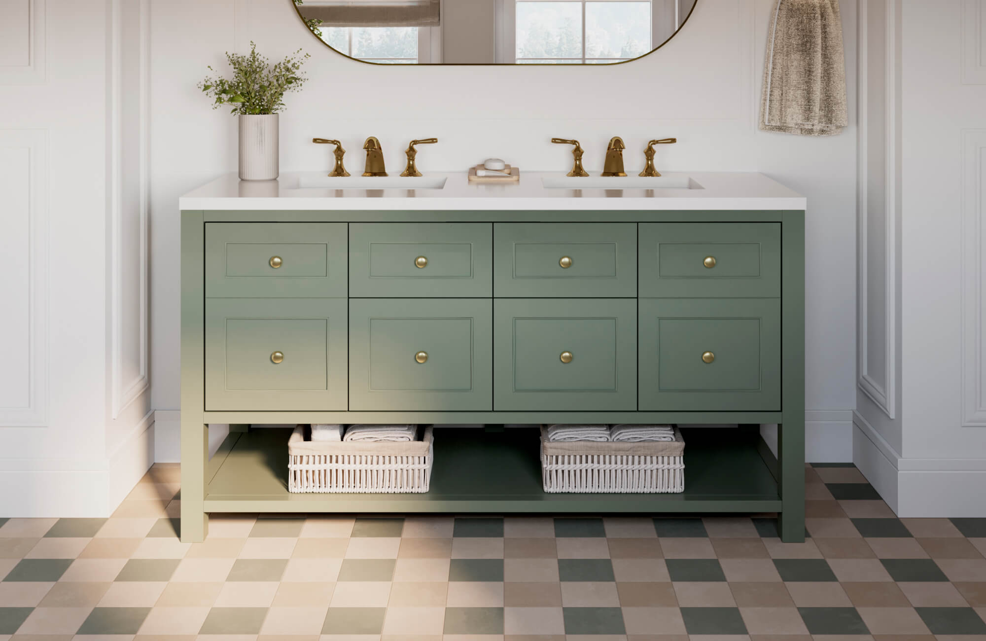 A modern bathroom vanity in a soft sage green finish features clean shaker-style cabinetry, a crisp white double-sink countertop, warm brass fixtures, and open lower shelving with woven baskets.