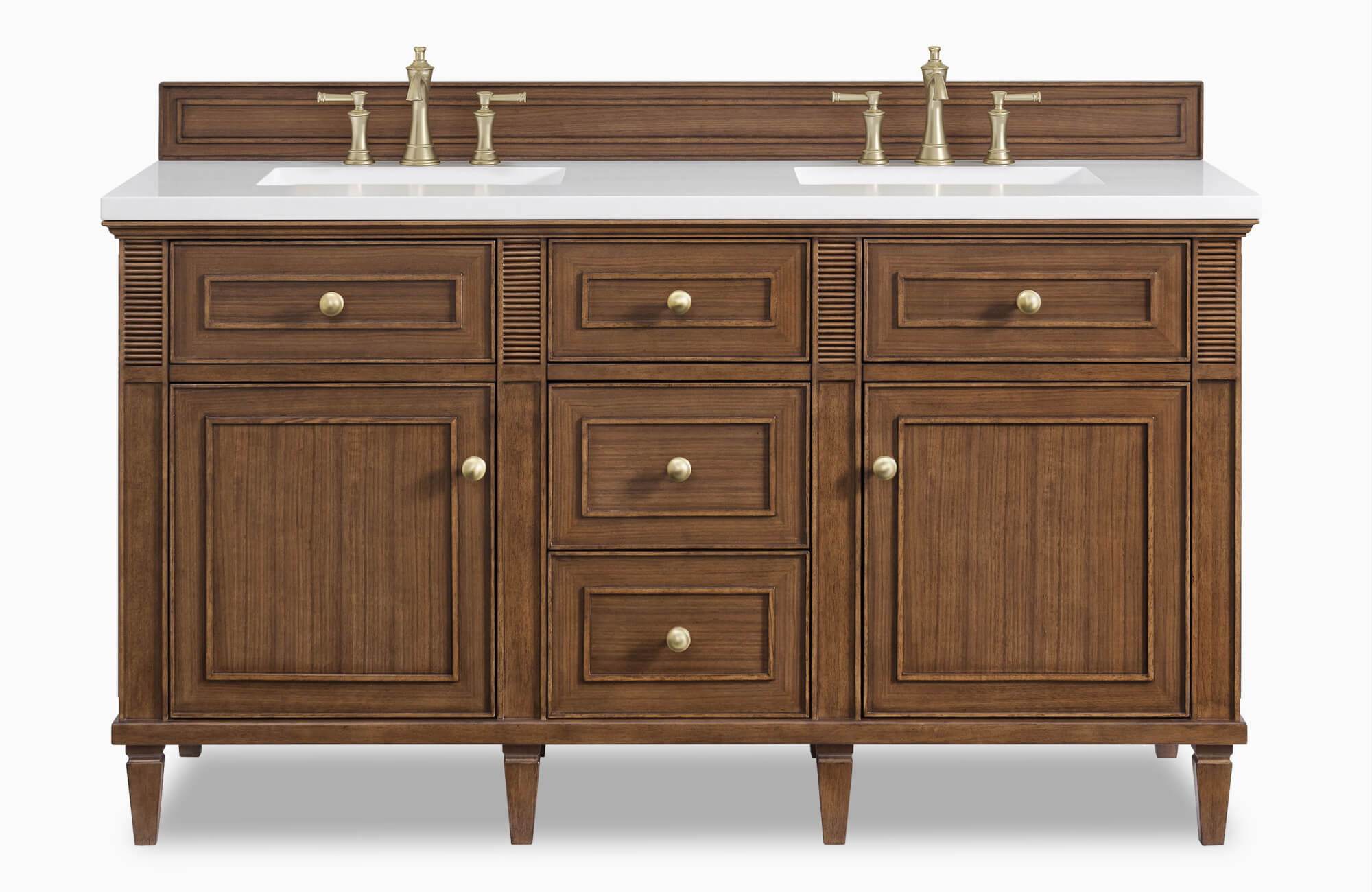 A modern bathroom vanity with rich wood cabinetry and classic panel detailing is topped with a smooth white double-sink countertop, accented by warm brass hardware and fixtures that blend traditional elegance.