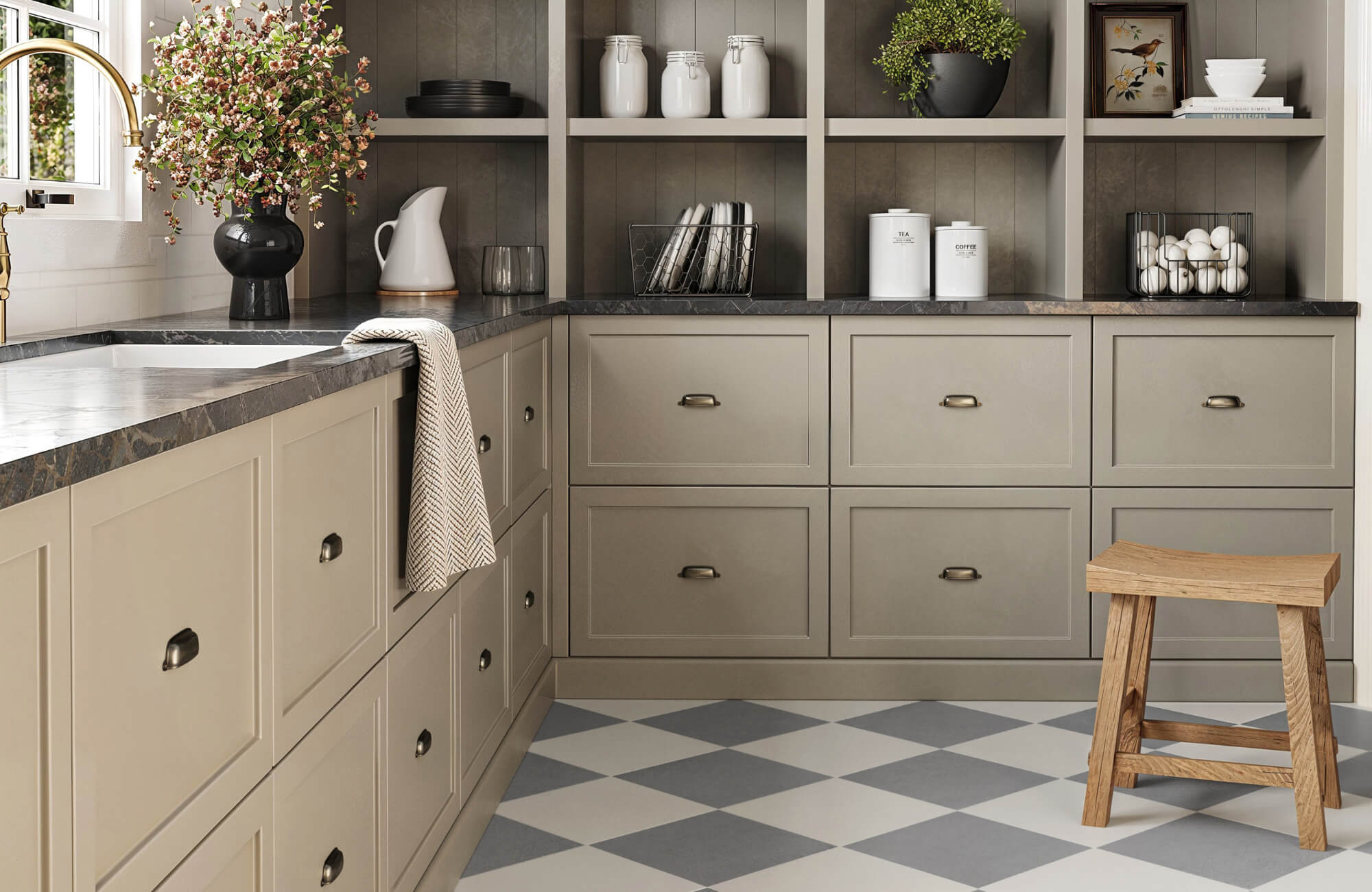 Transitional-style kitchen with taupe cabinetry, dark stone countertops, and soft gray and white checkerboard tile flooring.