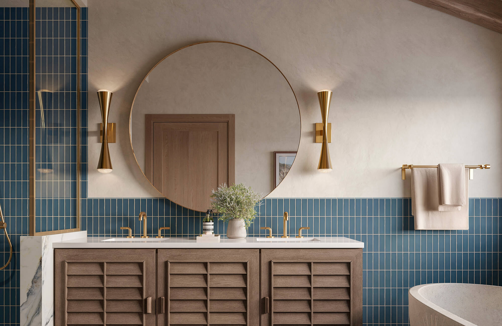 null A round brass-framed mirror centered above a double vanity with blue vertical tile, warm wood cabinetry, and gold wall sconces creates a clean, modern look.