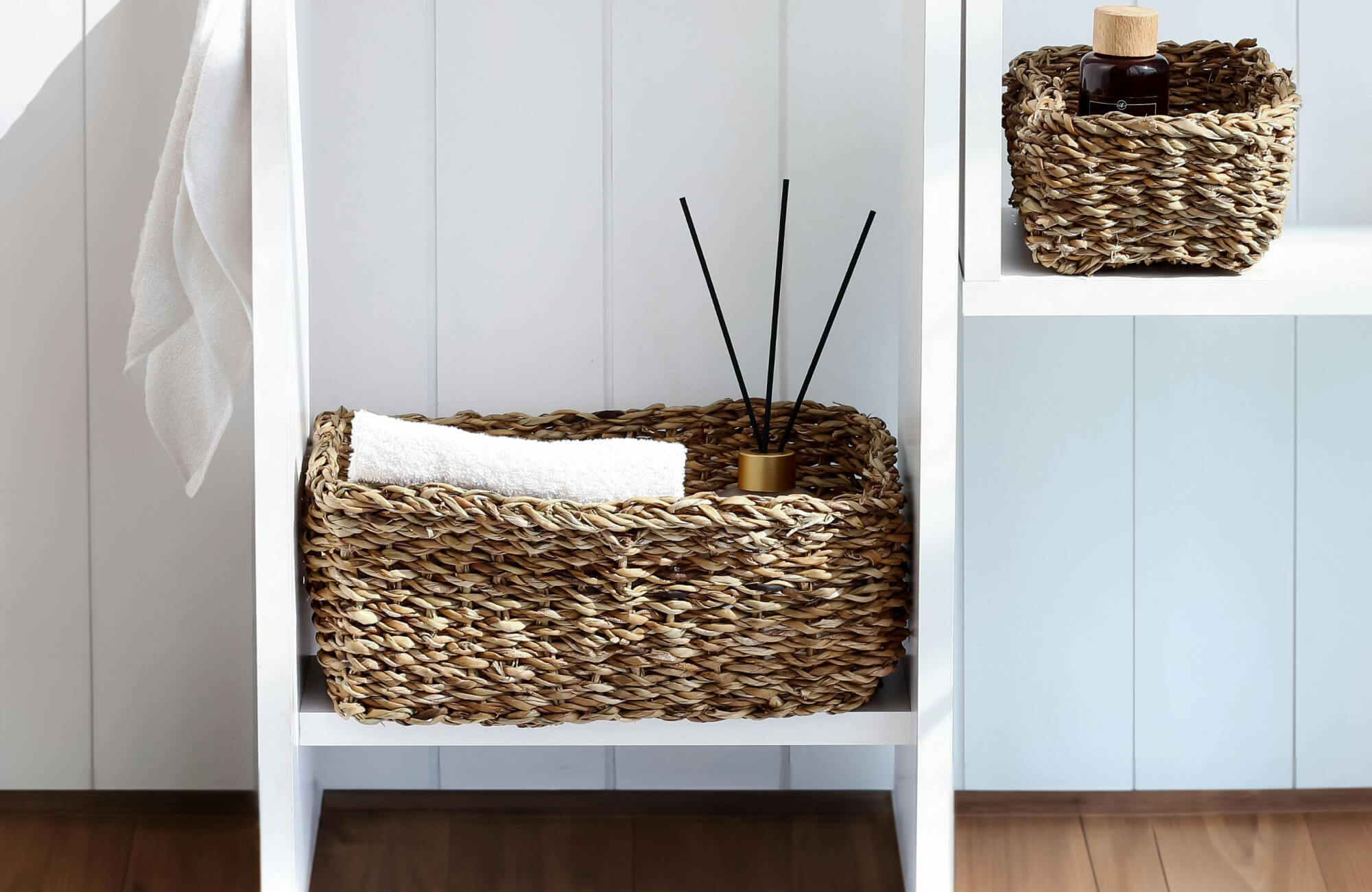 Woven storage baskets adding warm, natural texture to a rustic-inspired bathroom interior.