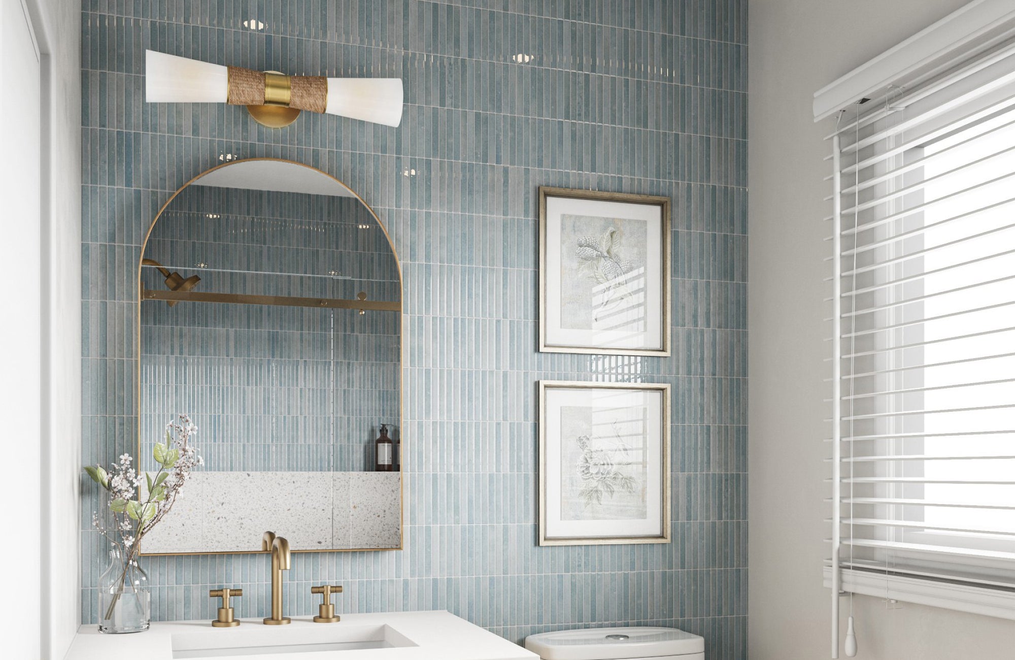 Slim arched mirror over single sink with terrazzo backsplash and vertical stacked tile wall.