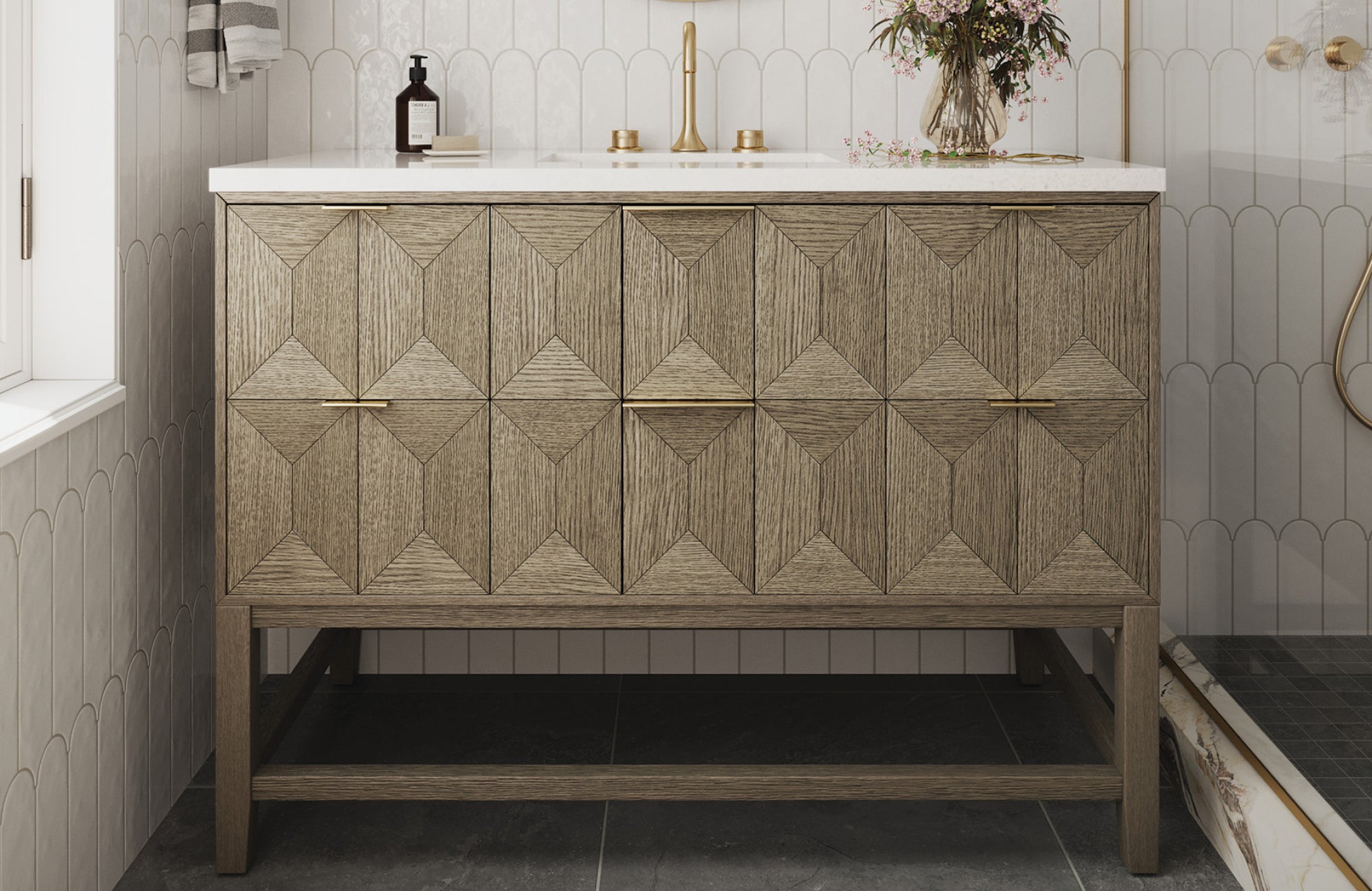 Geometric wood vanity mounted against the wall, contrasted with scalloped tile and gold hardware for a refined look.