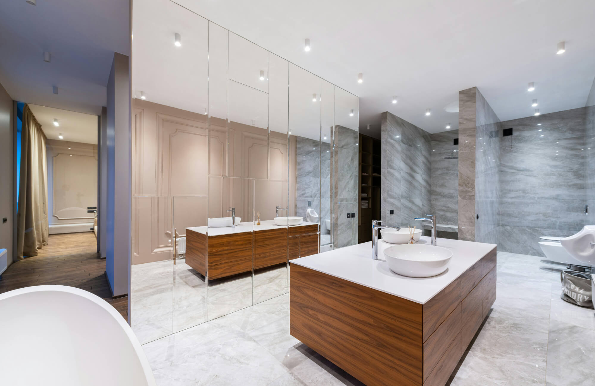 Freestanding double vanity positioned at the center of a large bathroom, offering a bold, open-concept focal point.