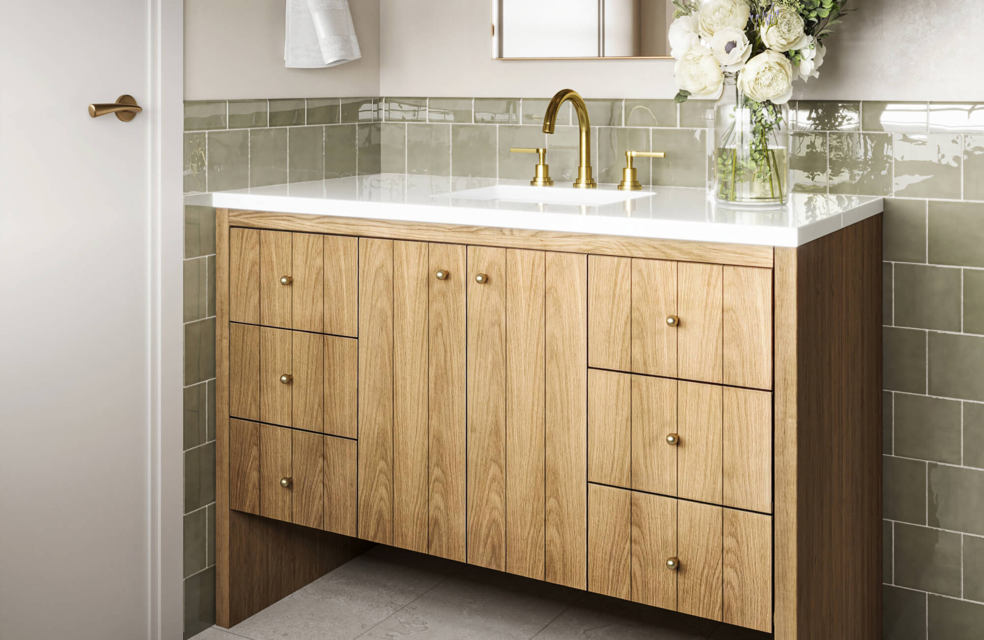 Transitional bathroom featuring light oak cabinetry, clean white countertop, soft gold fixtures, and glossy sage green tile for a breezy, modern vibe