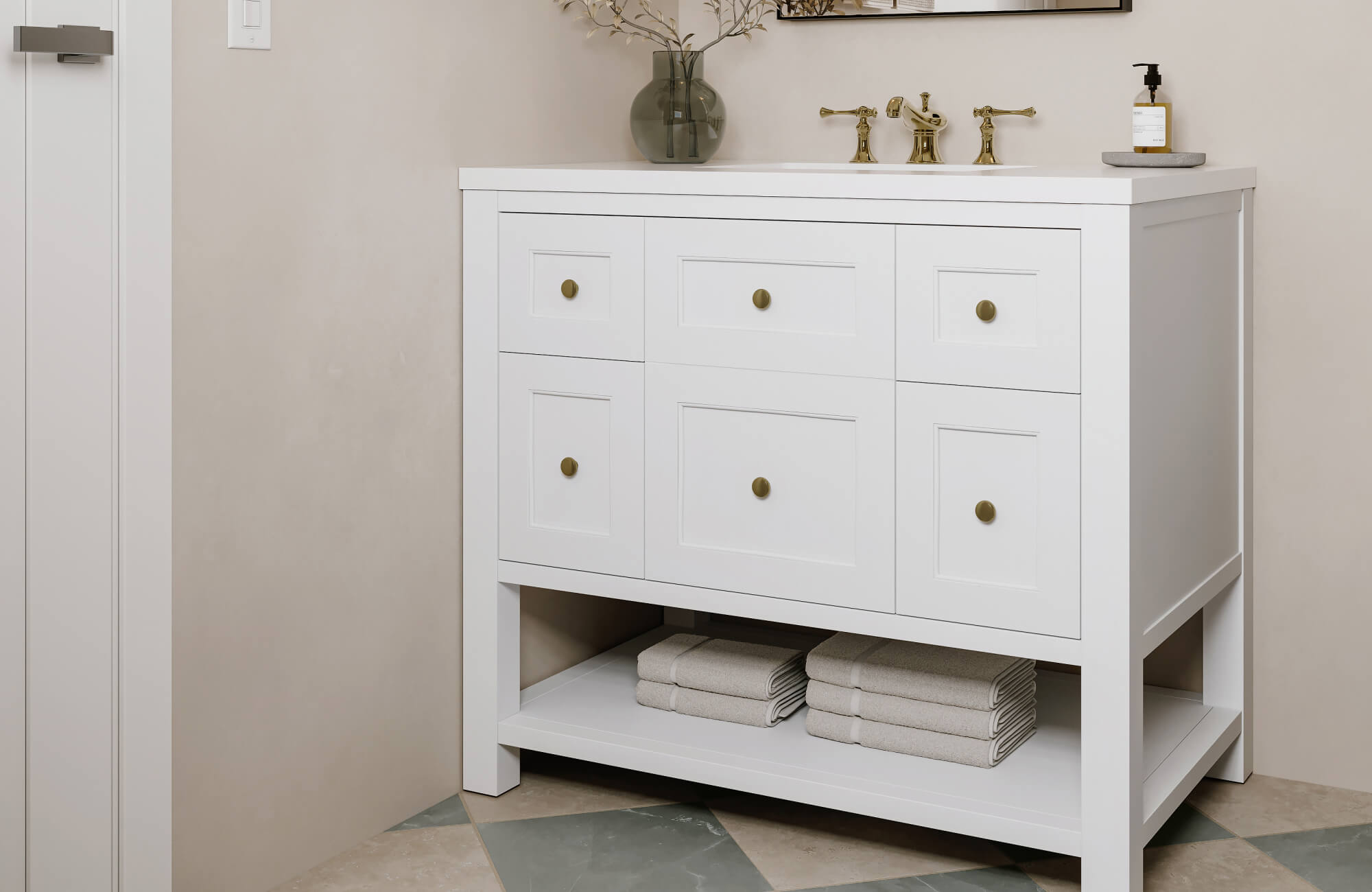 Bright bathroom with white shaker-style vanity, brass faucet, beige walls, and geometric tile flooring for a clean and timeless design contrast