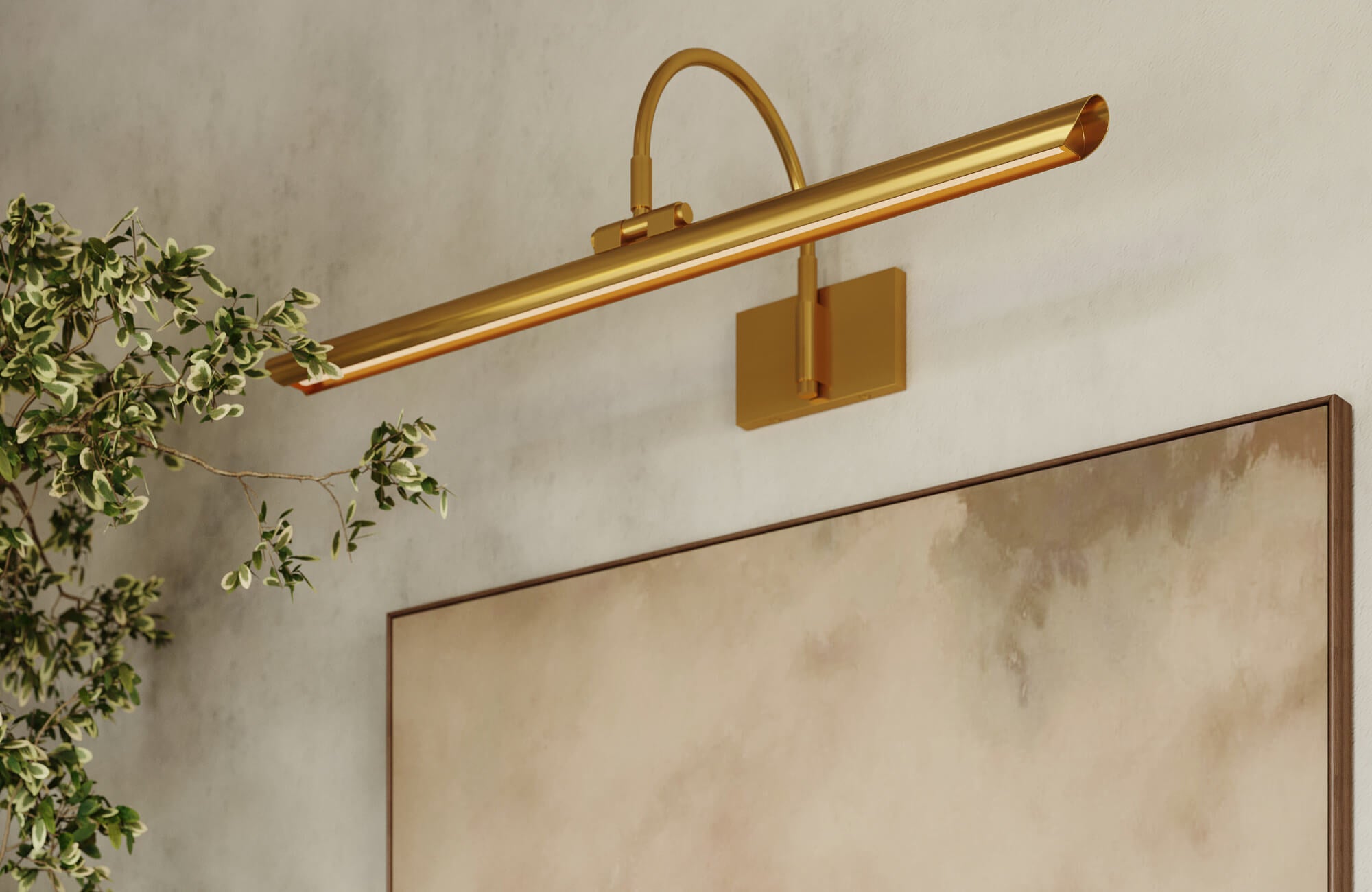 null A close-up of a sleek brass picture light mounted above a neutral abstract painting, styled with greenery for a soft, modern look.