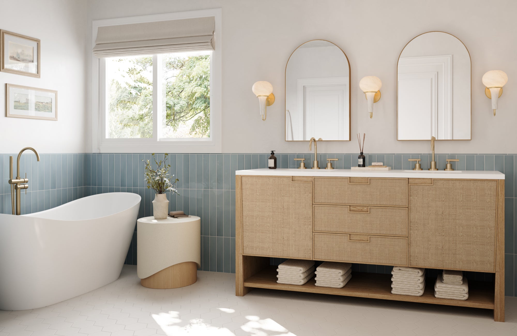Wall sconces and faucet in aged brass finish balance natural wood vanity and blue tile in a modern bathroom.