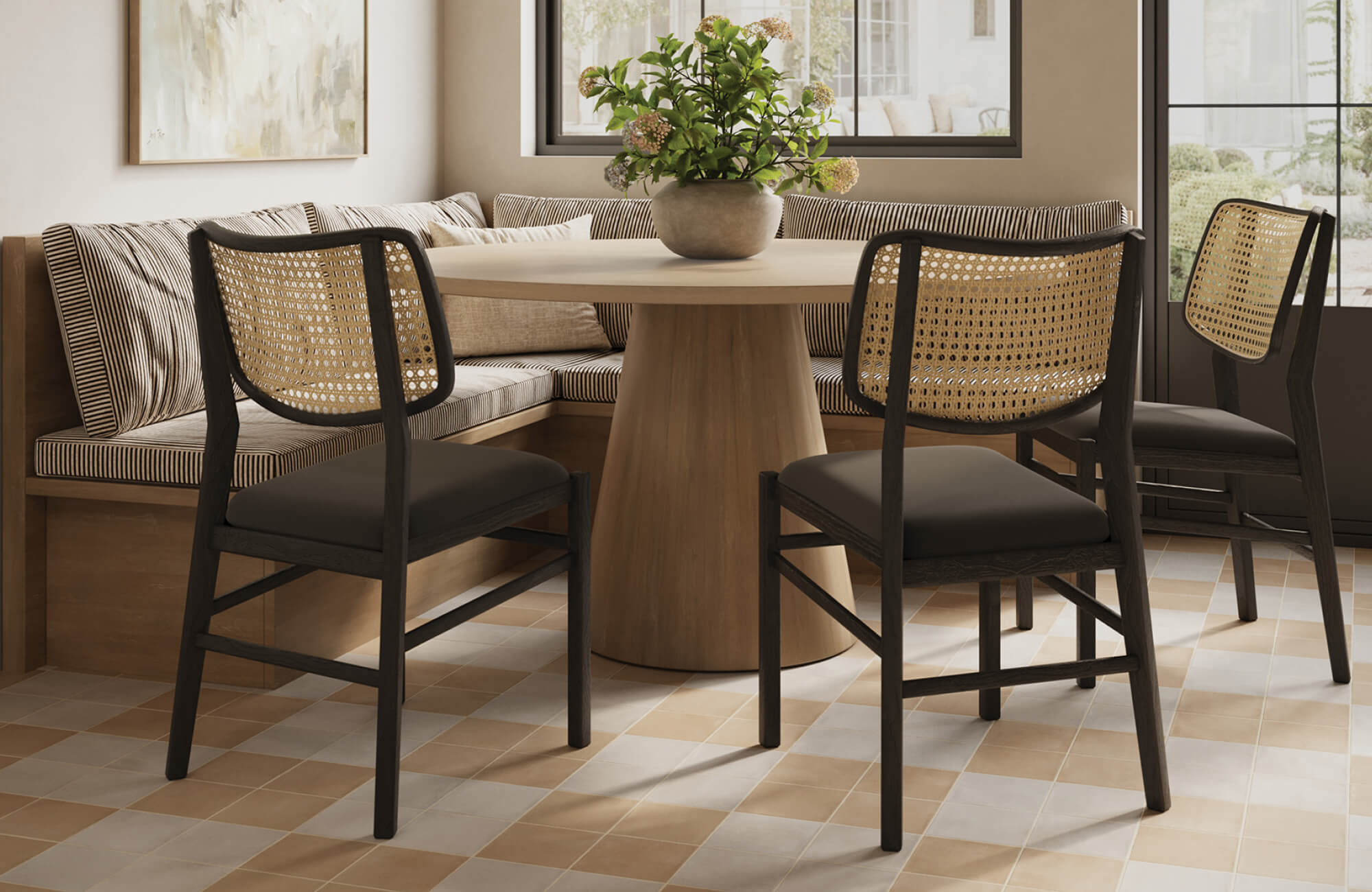 Woven-back dining chairs with dark frames paired with a light table, creating contrast while keeping seating visually open.