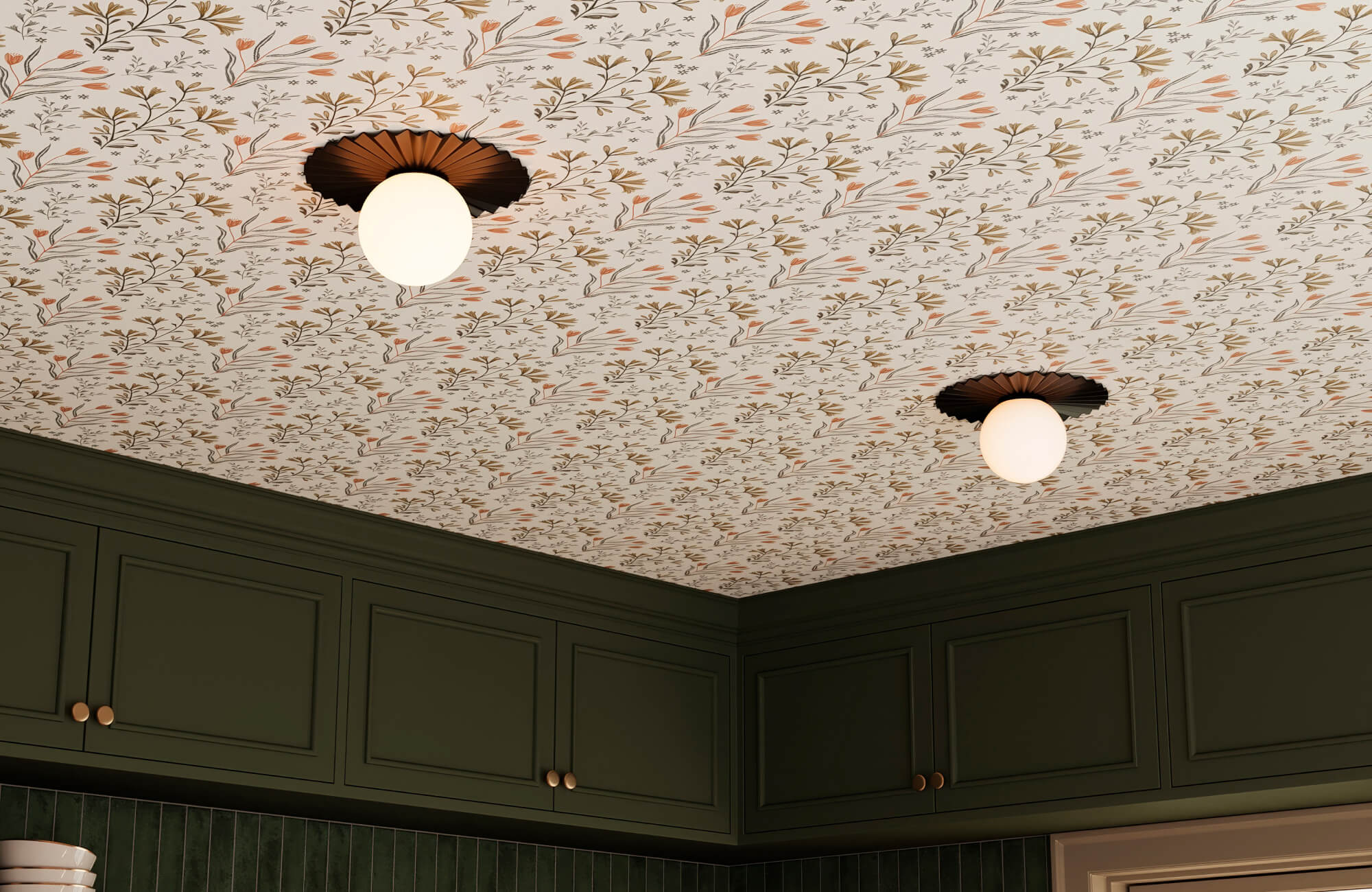 Floral-patterned wallpaper ceiling above deep green cabinetry with vertical green subway tile backsplash and warm globe ceiling lights.